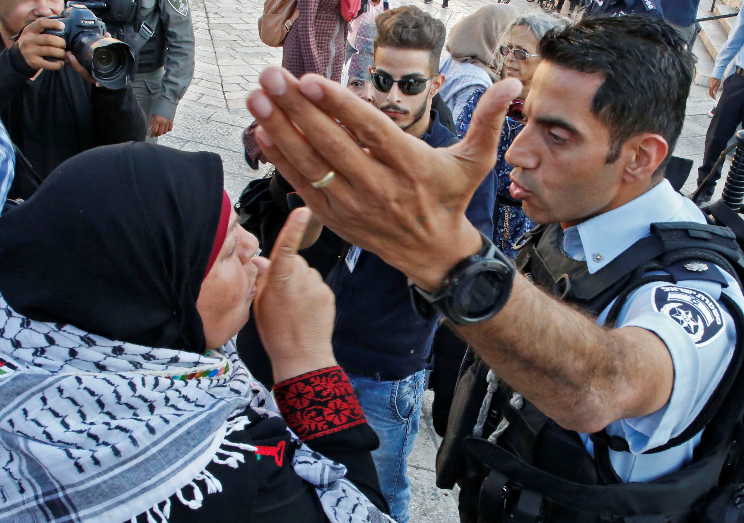 A Palestinian woman argues with a member of the Israeli security forces as they disperse a demonstration outside the Damascus Gate in the old city of Jerusalem on 15 May, 2018 marking the 70th anniversary of Nakba  (AFP)