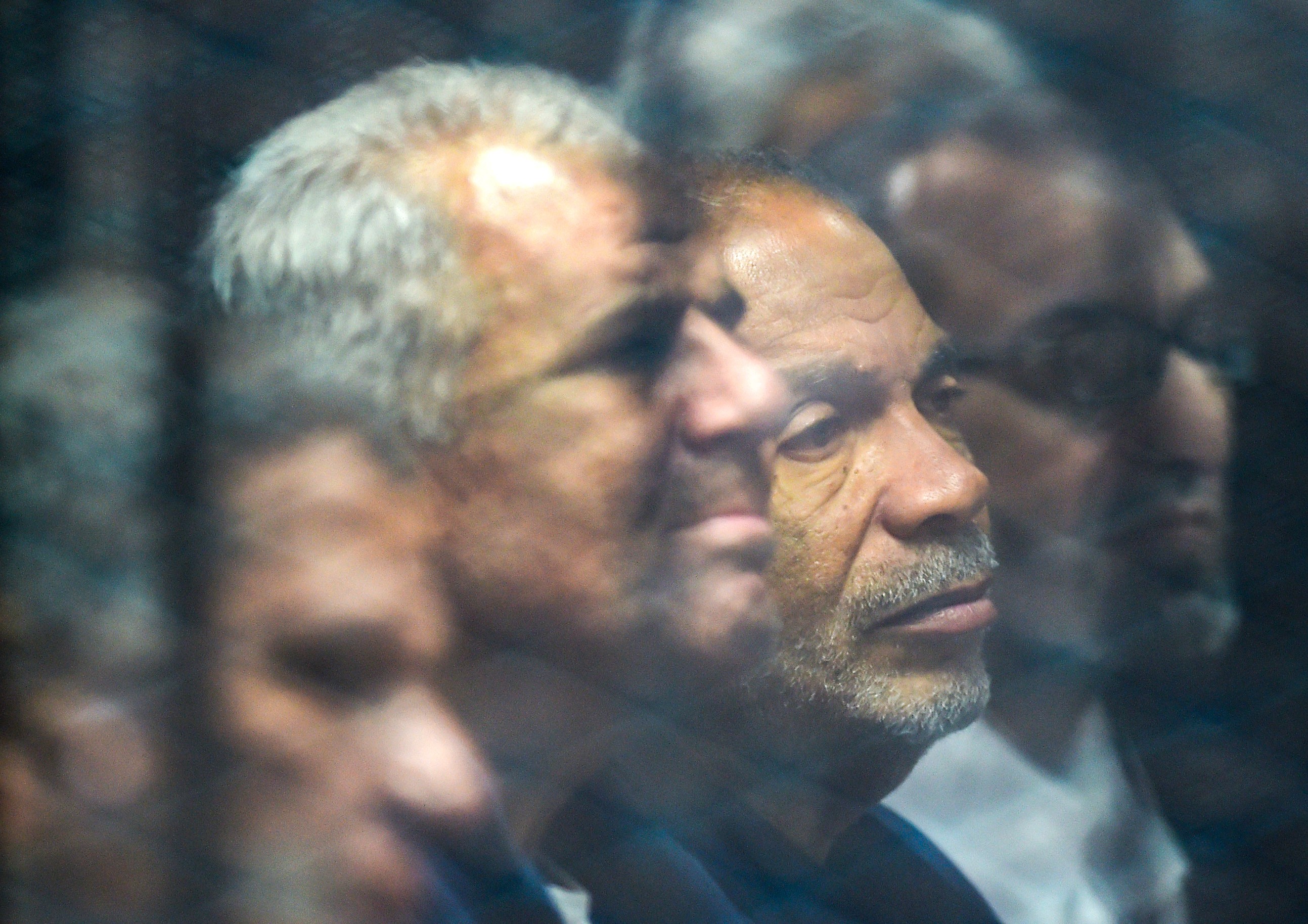 Senior Muslim Brotherhood member and former parliament speaker Saad al-Katatni (C-R) sits alongside fellow member Sobhy Saleh (C-L) behind bars in a glass cage during their trial over charges of breaking out of jail during the 2011 uprising against former president Hosni Mubarak's 29-year rule, at a make-shift courthouse in southern Cairo on December 2, 2018.