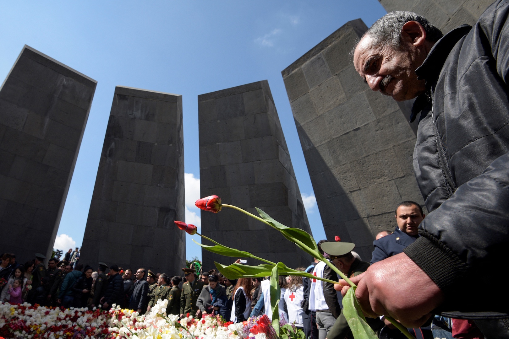 People attend a ceremony commemorating the 104th anniversary of the massacre of 1.5 million of Armenians by Ottoman forces in 1915, at the Tsitsernakaberd memorial in Yerevan on 24 April 2019 (AFP)