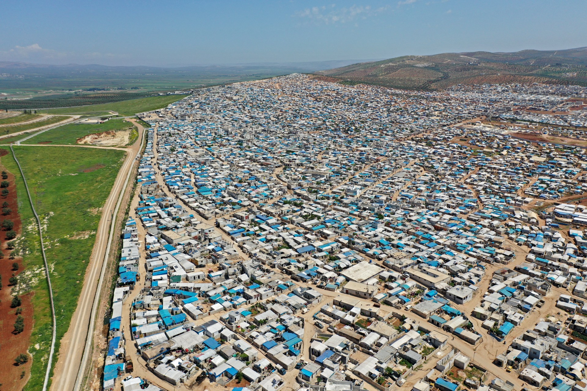 An aerial view shows the Atme camp for displaced Syrians close to the border with Turkey in Syria's northwestern Idlib province, on 19 April, 2020 (AFP)