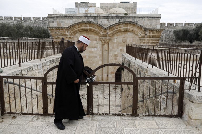 A Muslim man checks a gate closed by Israeli police at al-Aqsa Mosque compound in Jerusalem’s Old City on 18 February (AFP)