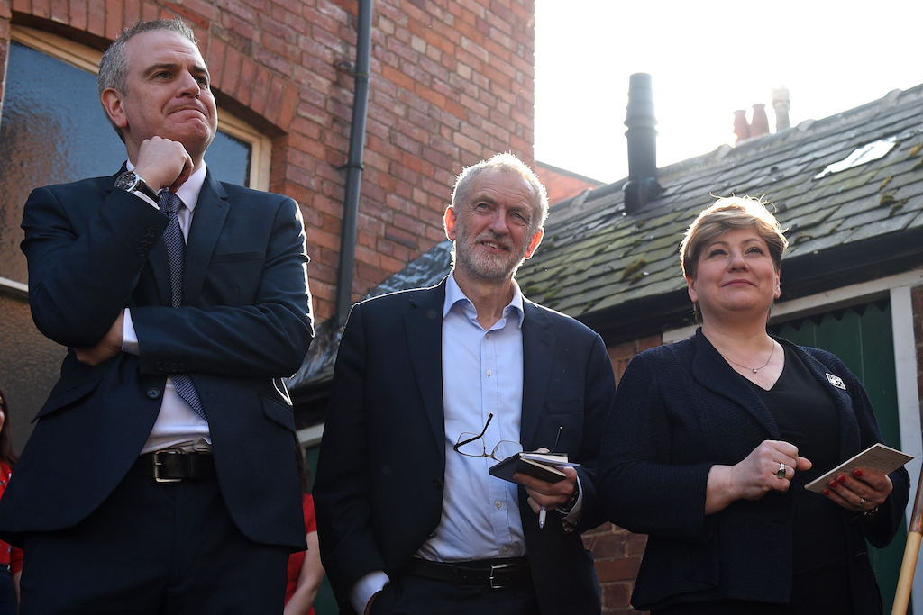 Opposition Labour party leader Jeremy Corbyn (C) waits with shadow foreign secretary Emily Thornberry (R) and Prospective Parliamentary Candidate for Broxtowe, Greg Marshall (L) ahead of Corbyn's address at a rally on February 23, 2019, in Broxtowe, central England (AFP)