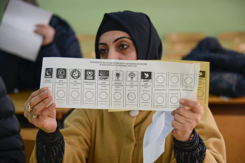 An election official shows a ballot during the counting at a polling station located in a school of Diyarbakir in southeastern Turkey