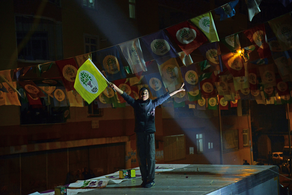 A young supporter of the pro-Kurdish Peoples' Democratic Party (HDP) celebrates after the local elections, in Diyarbakir (AFP)