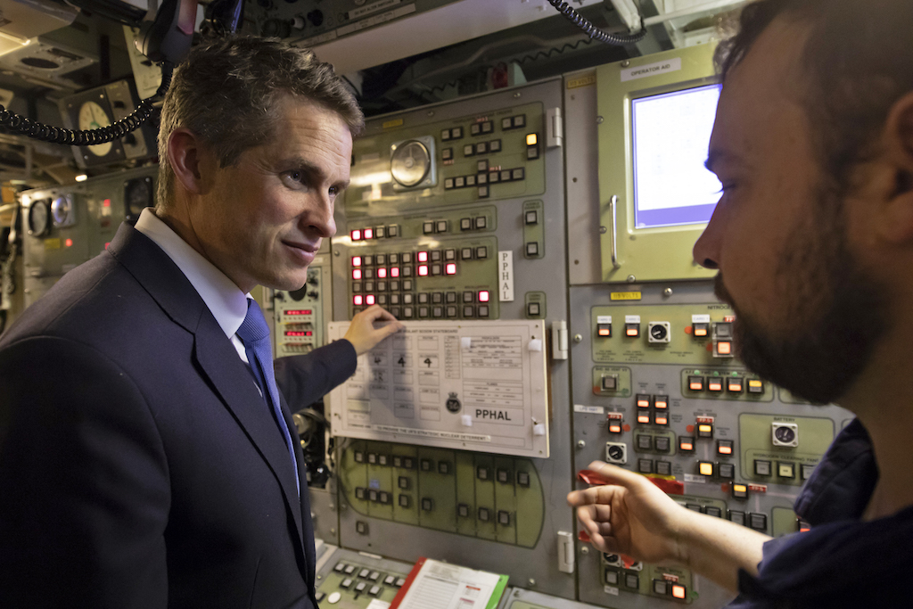 Former Defence Secretary Gavin Williamson (L) speaks with staff during a visit to Vanguard-class submarine HMS Vigilant at HM Naval Base Clyde (AFP)