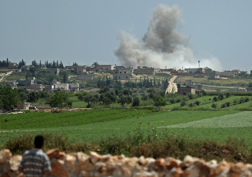 Smoke billows after reported shelling on the Syrian village of Kafr Ein in the southern countryside of the militant-held Idlib province (AFP)