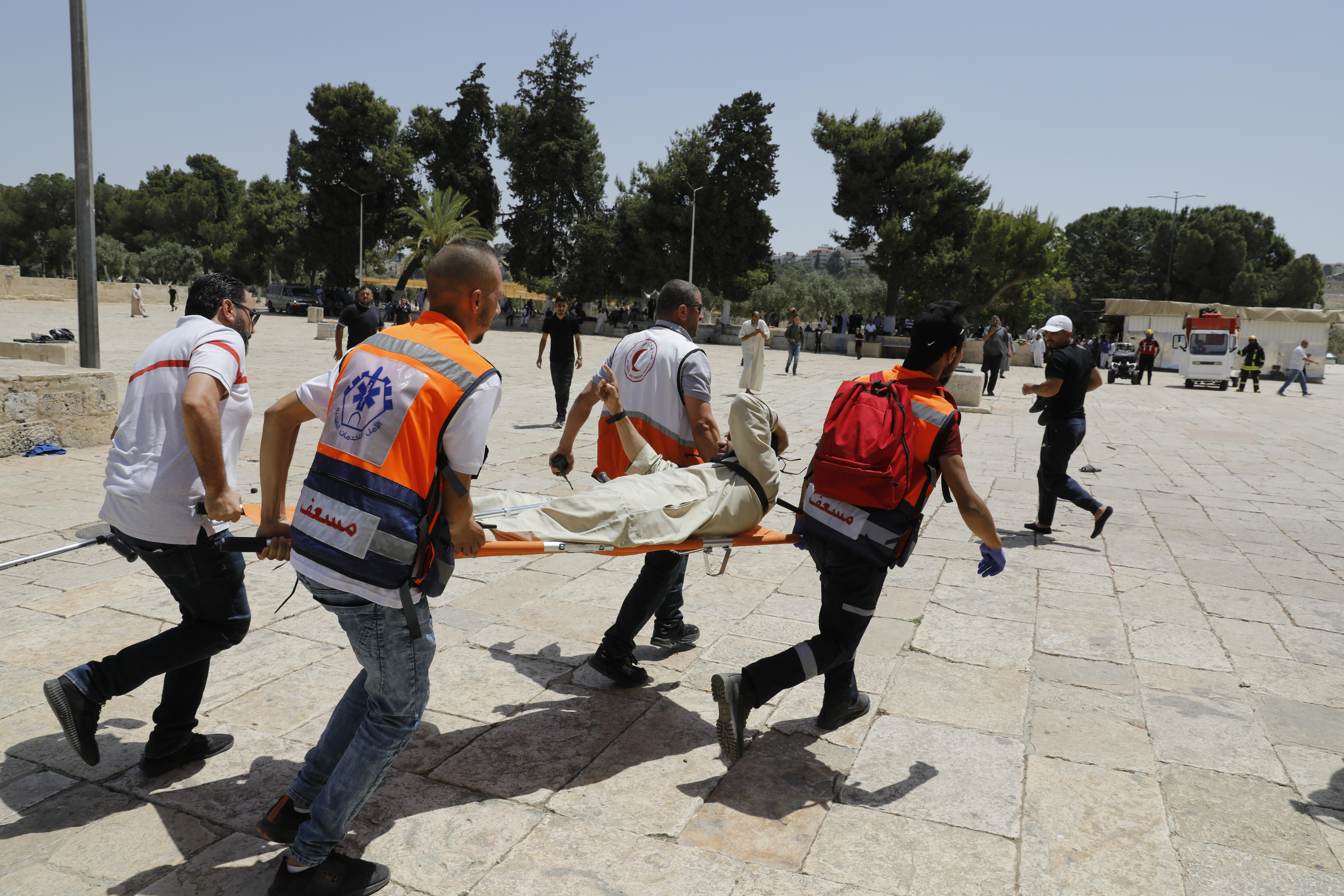 Palestinian medics evacuate a man at the al-Aqsa Mosque compound, in the Old City of Jerusalem (AFP)