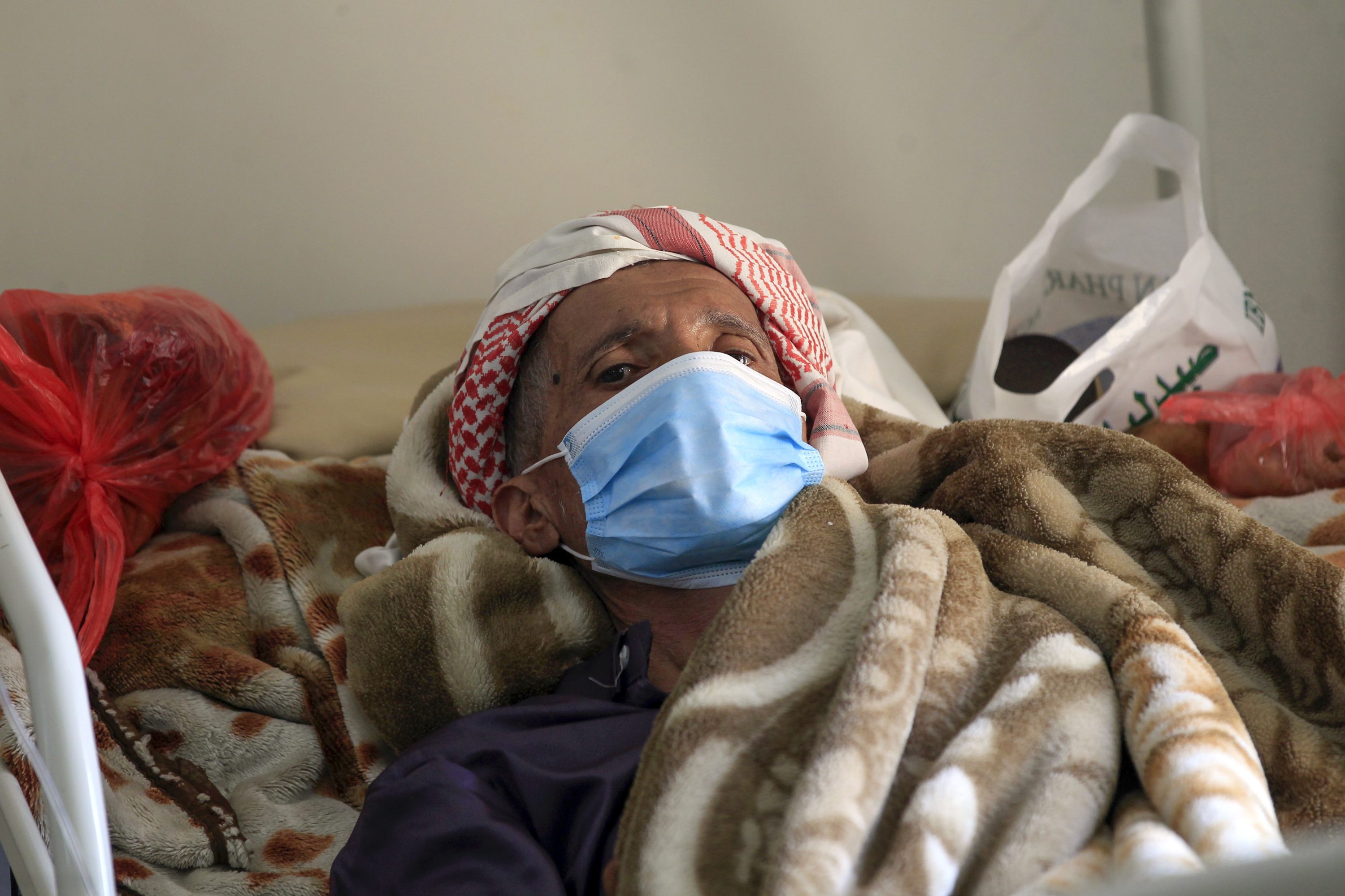 A Yemeni man suffering from cancer lies on a bed as he receives medical treatment at the National Oncology Centre in the capital Sanaa (AFP)