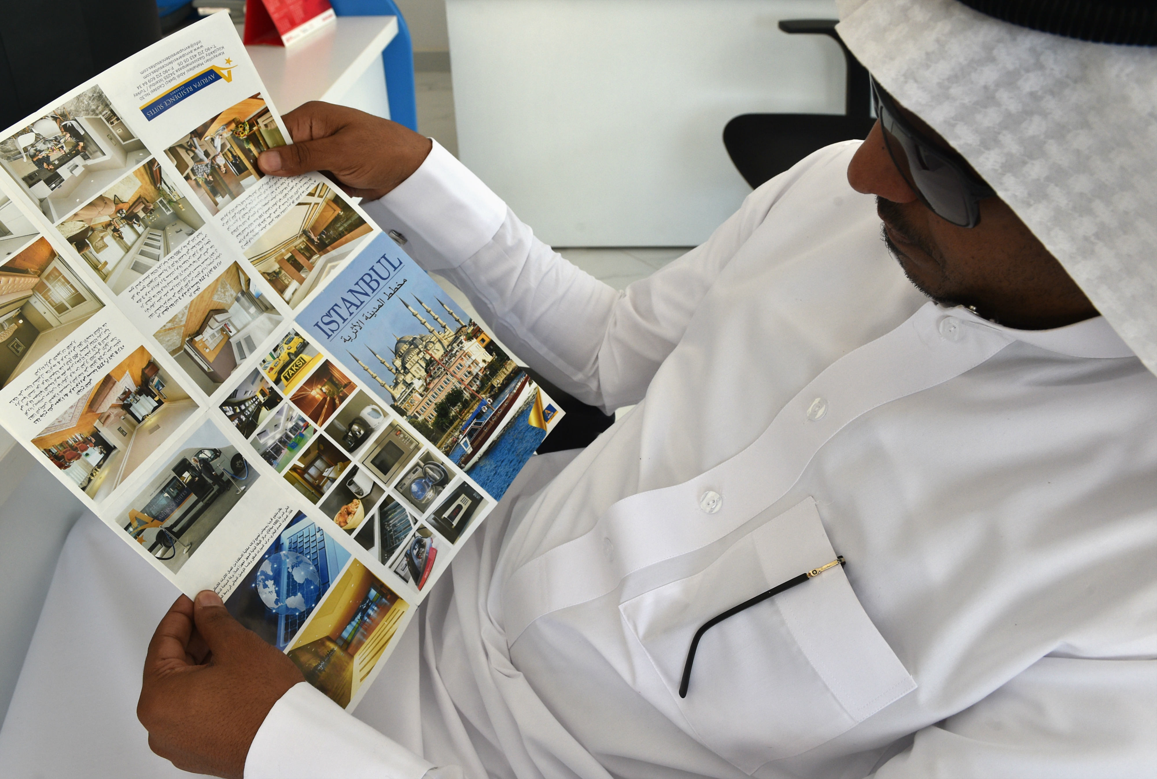 A Saudi customer looks at a touristic leaflet brochure about Turkey at a travel agency in the capital Riyadh (AFP)