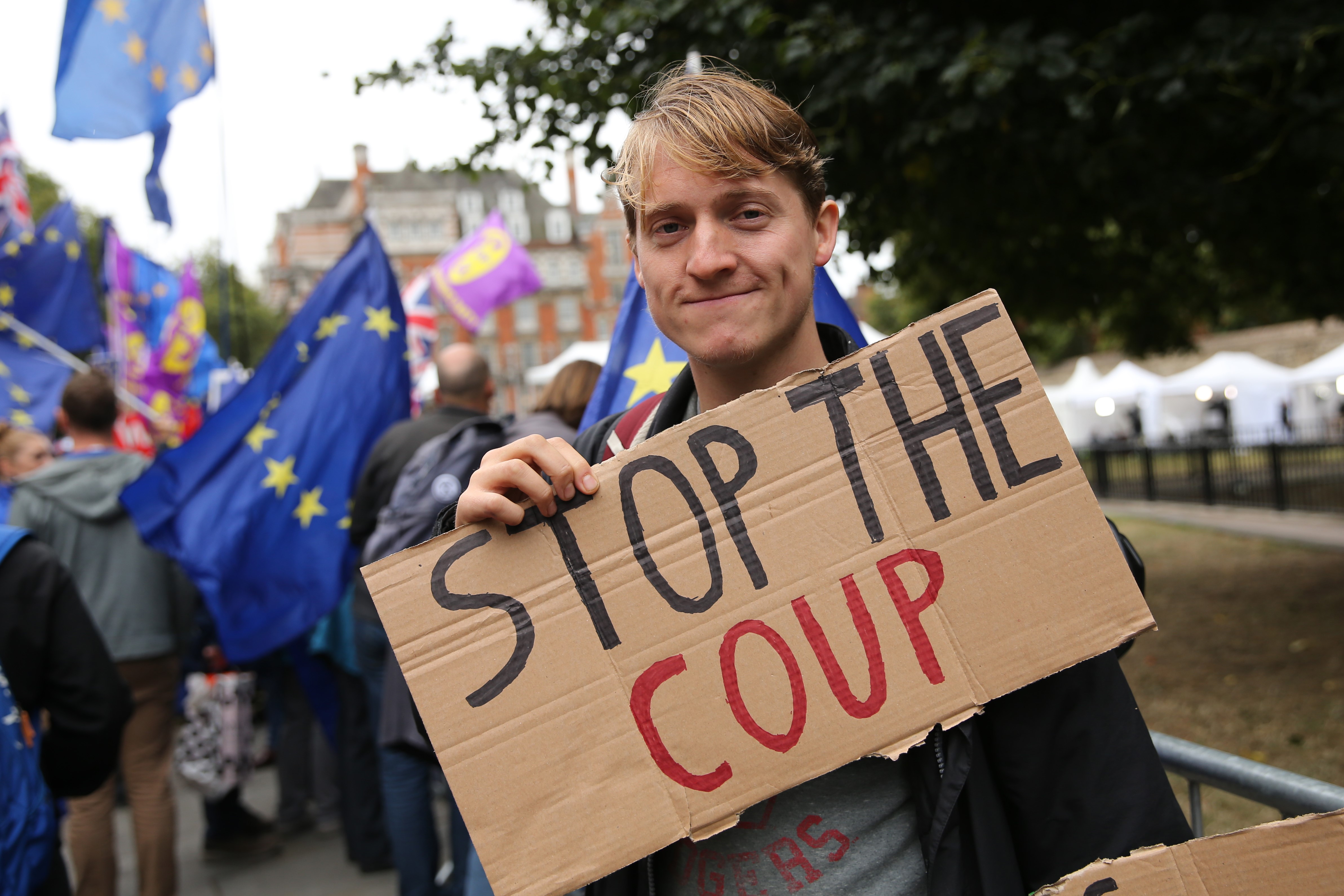 Anti-Brexit protesters stand protest outside the Houses of Parliament in London on September 9, 2019