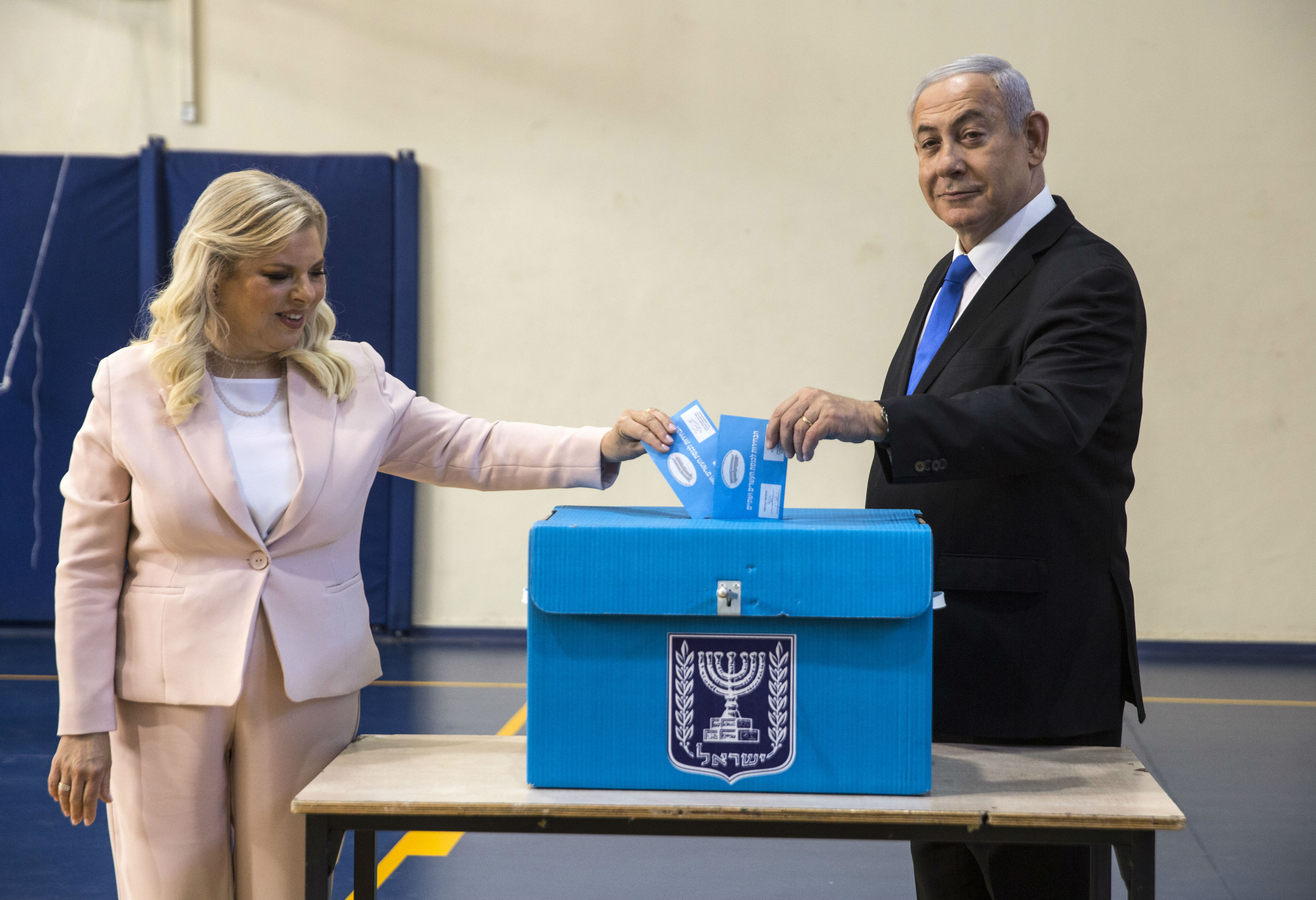 Israeli Prime Minister Benjamin Netanyahu and his wife Sara casts their votes at a voting station in Jerusalem (AFP)
