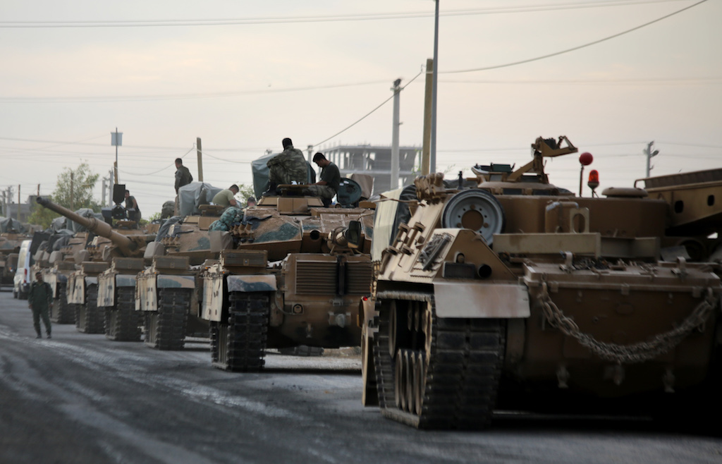 Tanks are pictured lined up as Turkish soldiers and Pro-Turkish Syrian fighters deploy near the Turkish village of Akcakale along the border with Syria (AFP)