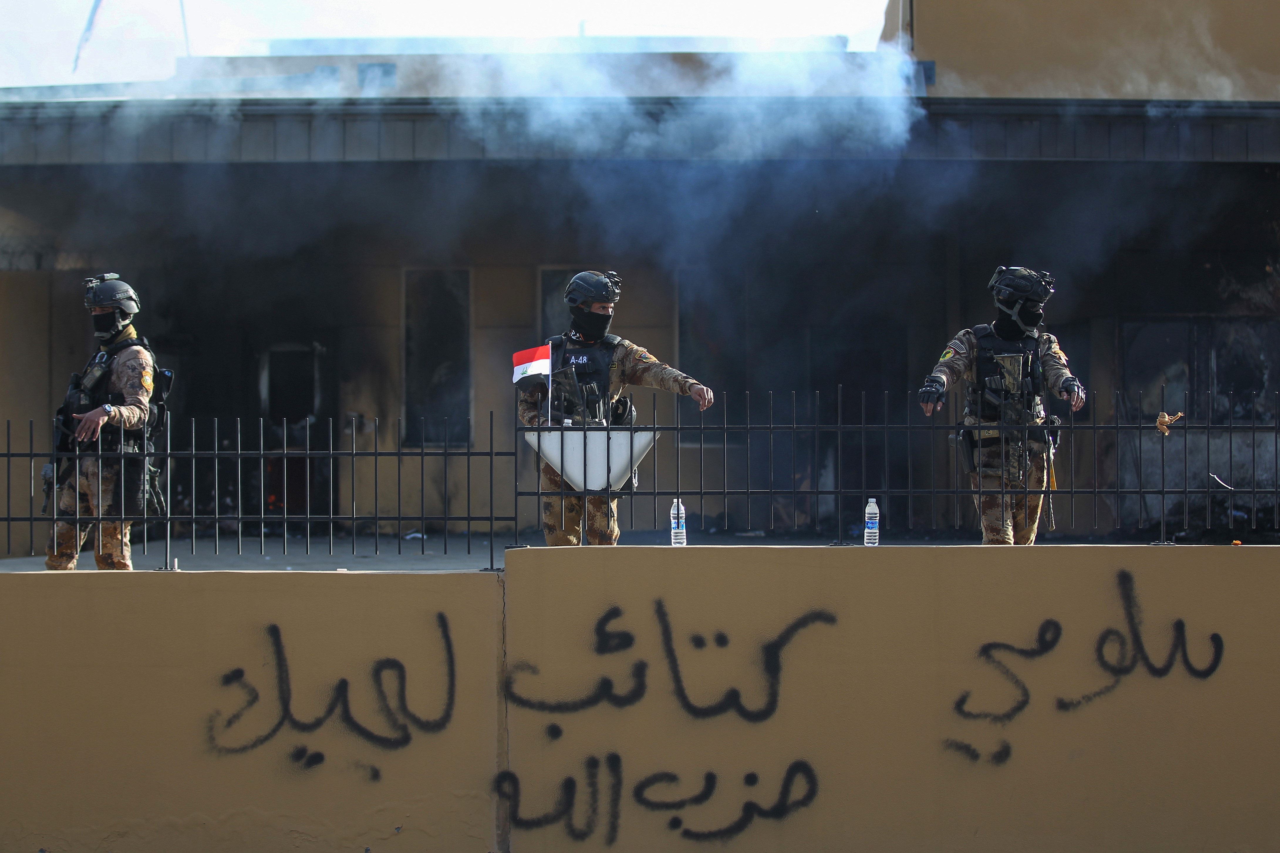 Iraqi security forces are deployed in front of the US embassy in the capital Baghdad, on 1 January (AFP)