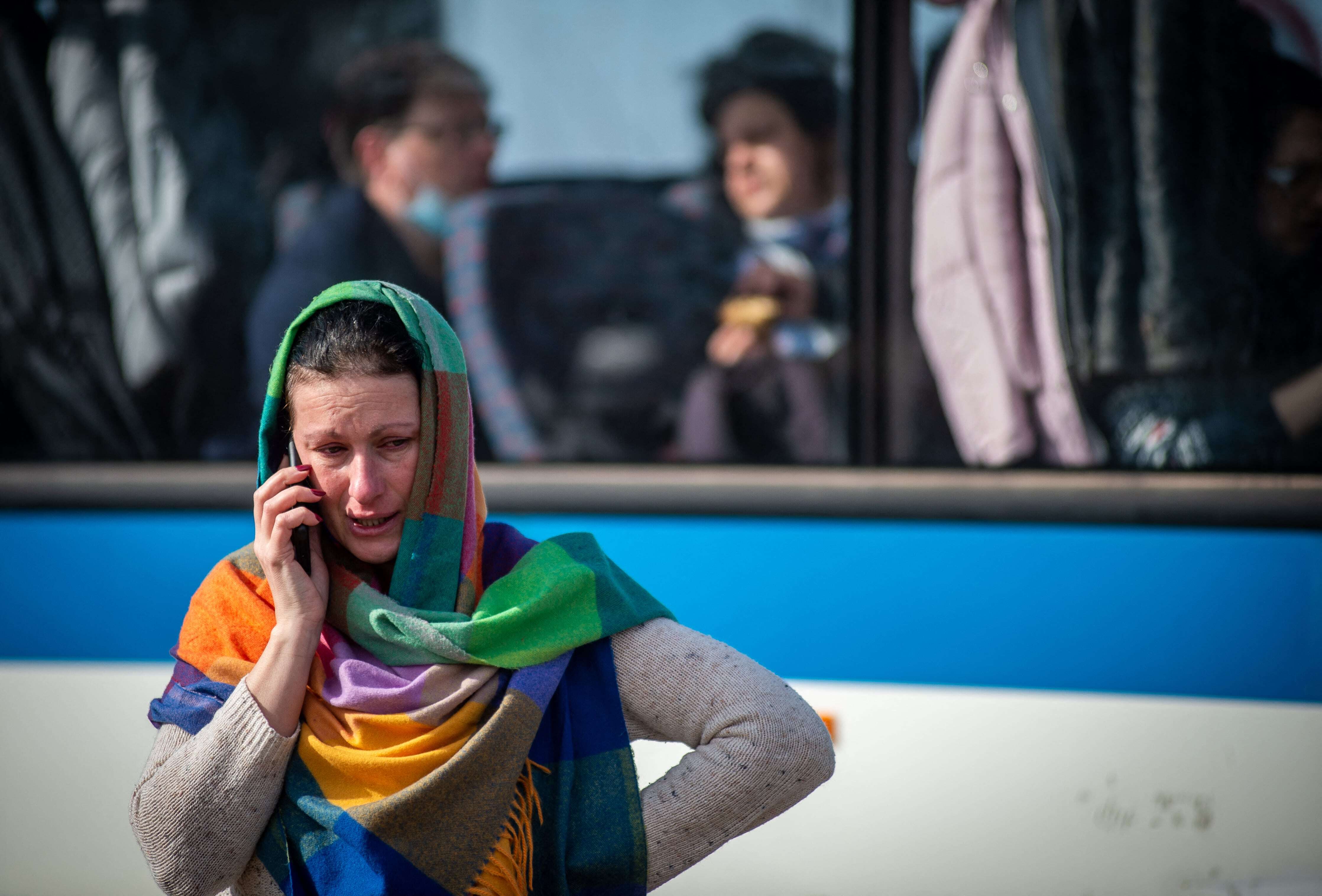 A Ukrainian woman makes a phone call after crossing the Slovak-Ukrainian border 
