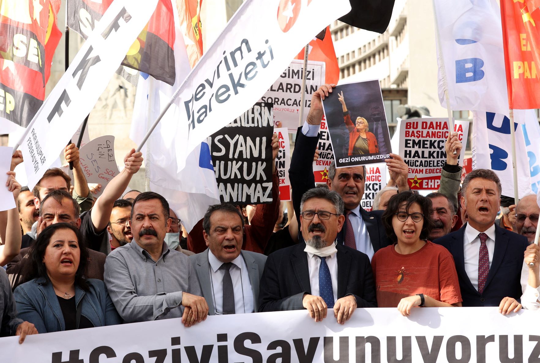 Protesters hold placards and shout slogans in Ulus Square in Ankara on April 26, 2022 during a rally in support of civil society leader Osman Kavala (AFP)