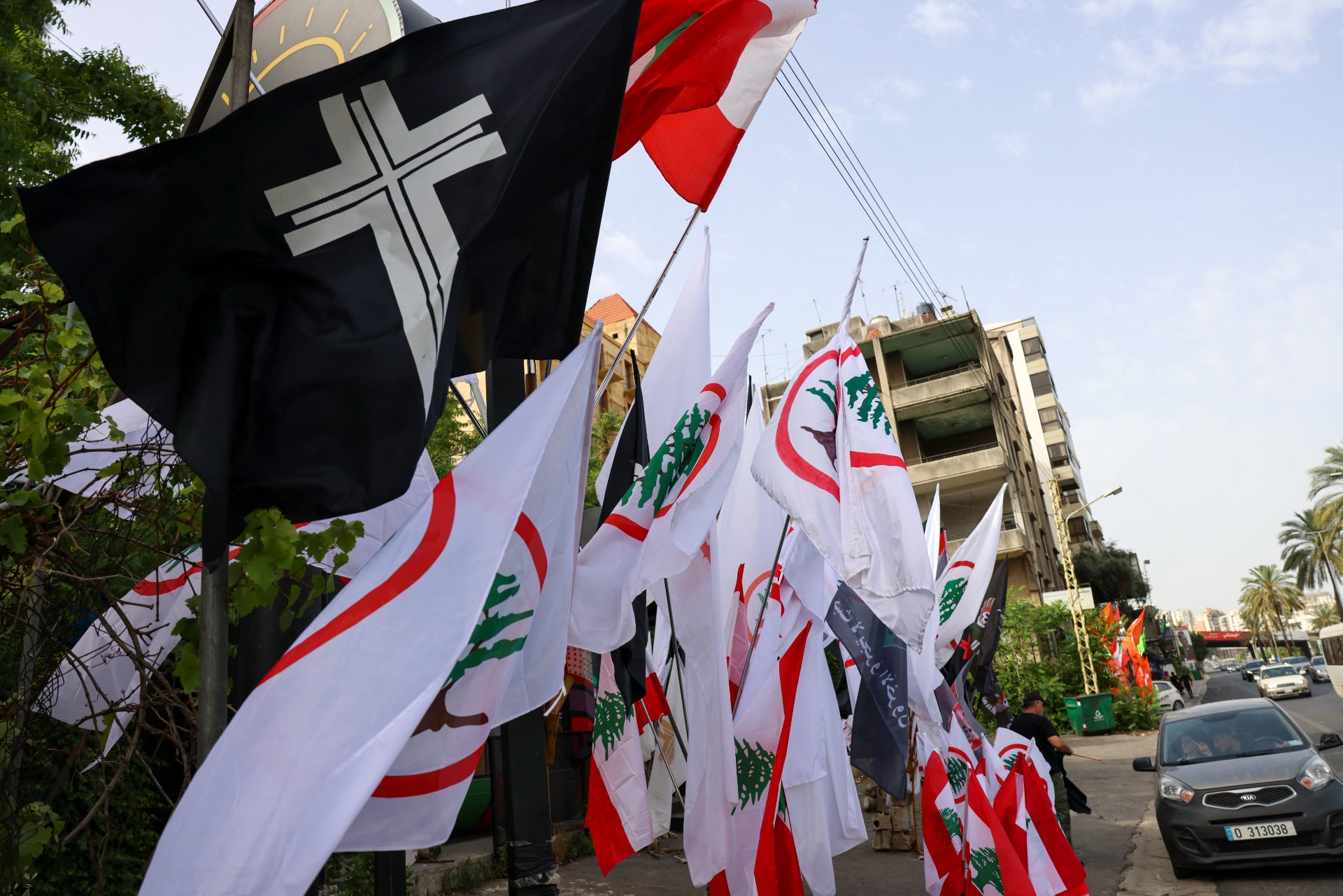Flags of the Lebanese Forces political party sway in the wind outside a restaurant in the coastal city of Byblos (Jbeil) (AFP)