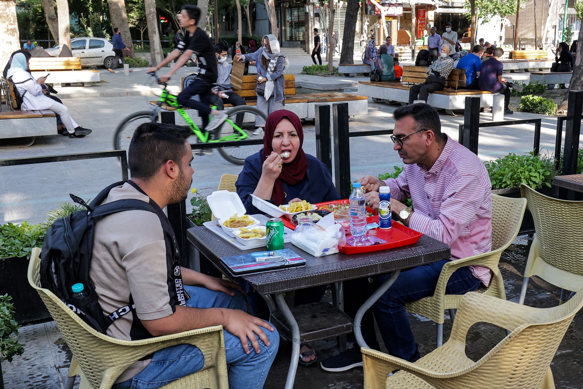 People have a meal together along the Chaharbagh Boulevard in Iran's central city of Isfahan (AFP)