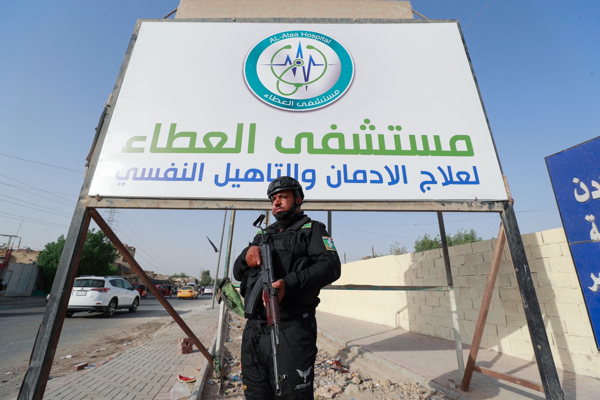 A member of Saraya al-Salam, Sadr's military wing, stands guard in Baghdad's Sadr City (AFP)