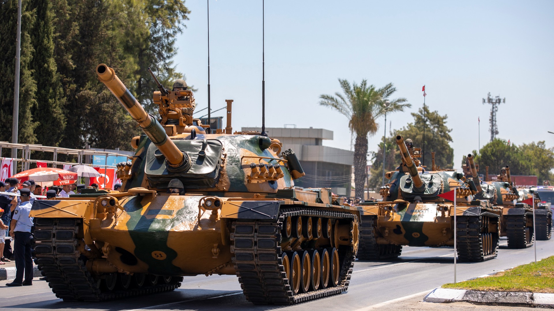 Turkish soldiers appear riding US-made M48 tanks, during an official ceremony commemorating Turkey's 1974 invasion of Cyprus (AFP/file photo)