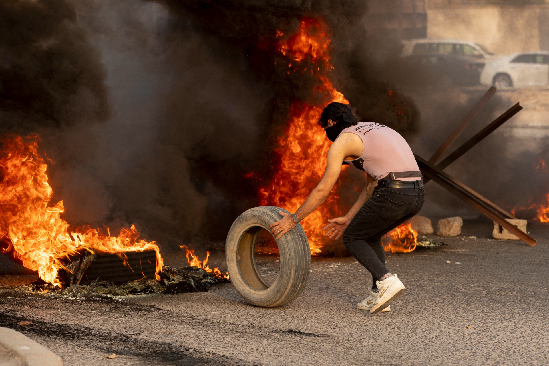 A supporter of Sadr blocks a road with burning tyres during a demonstration in Iraq's southern city of Basra (AFP)