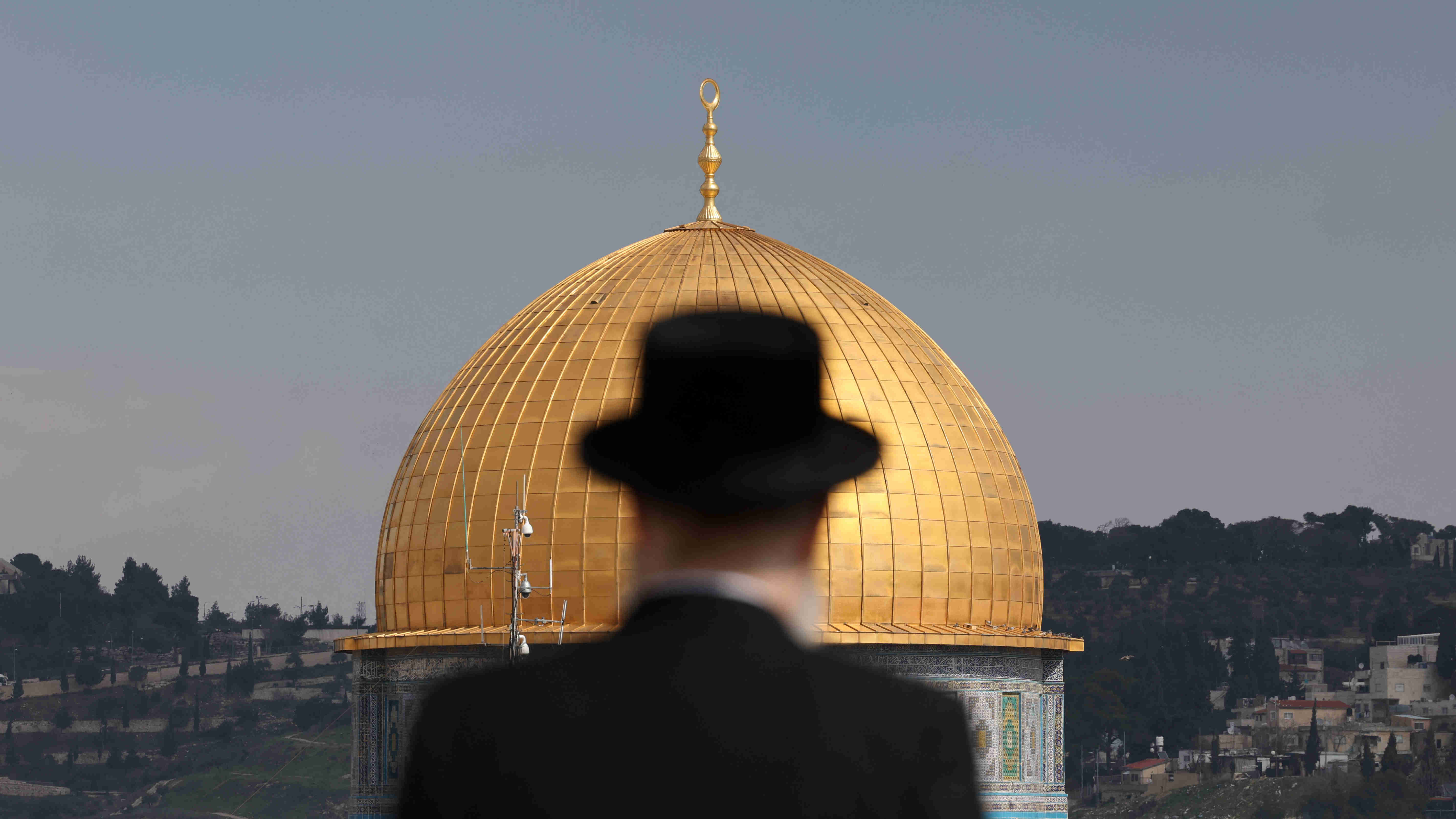 An ultra-Orthodox Jewish man stands at the Jewish quarter in Jerusalem's Old City overlooking the Dome of the Rock in al-Aqsa Mosque on 12 February 2023 (AFP)