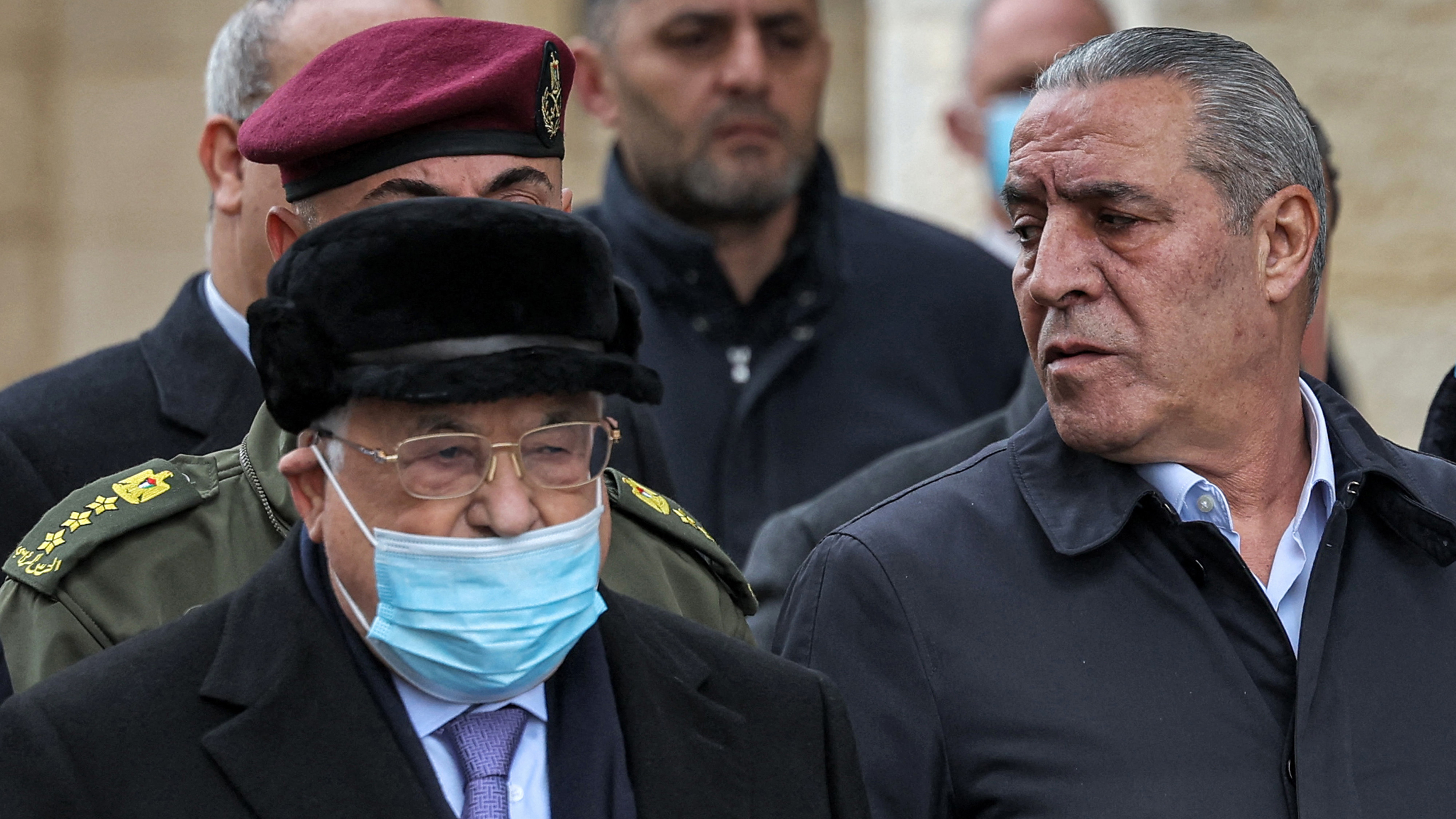 Palestinian president Mahmud Abbas and Hussein al-Sheikh attend the funeral of late PM Ahmad Qurei in the occupied West Bank city of Ramallah on 22 February 2023 (AFP)