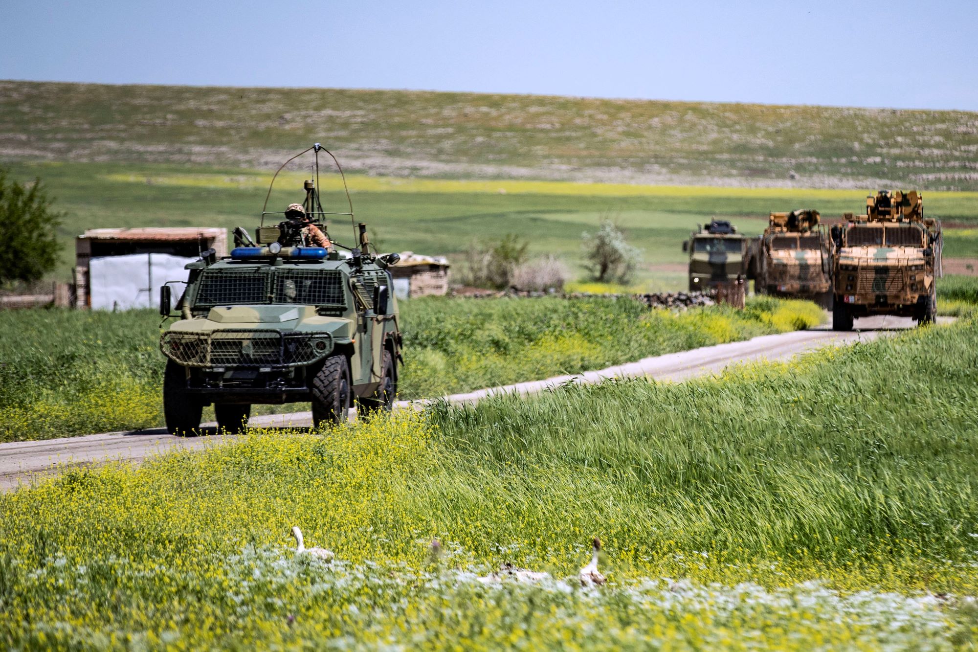 Turkish and Russian military vehicles patrol in the countryside of Rumaylan (Rmeilan) in Syria's northeastern Hasakeh province bordering Turkey, on April 27, 2023 (AFP)