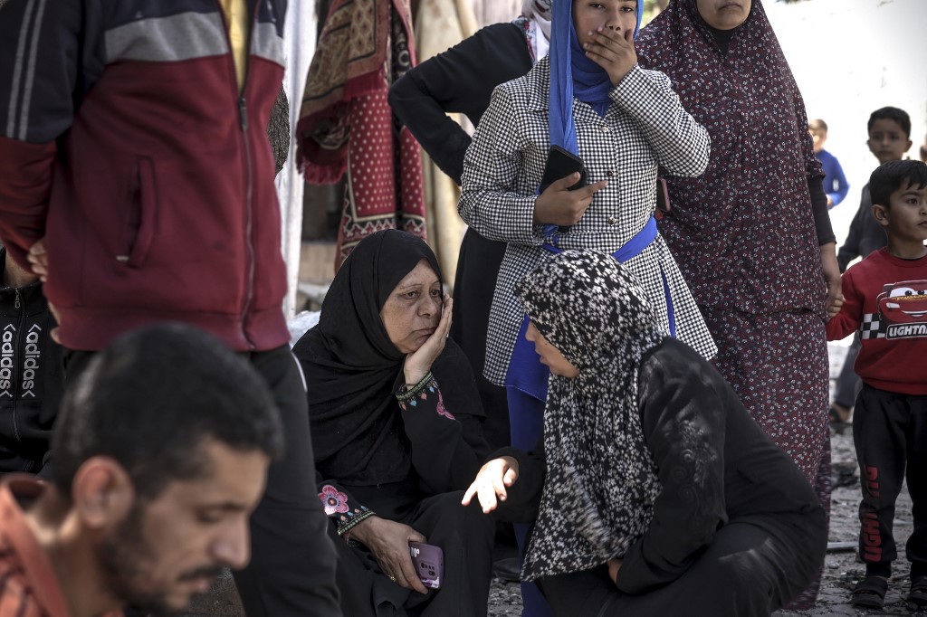 People react following an Israeli air strike in Beit Lahia in the northern Gaza Strip, on May 13, 2023. 