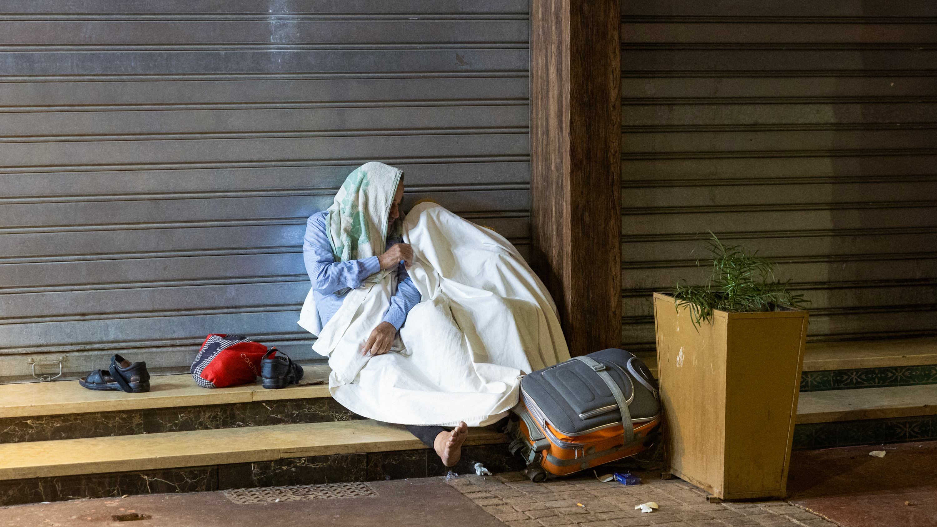 Residents take shelter ouside closed shops following an earthquake in Marrakesh on 9 September 2023 (AFP)