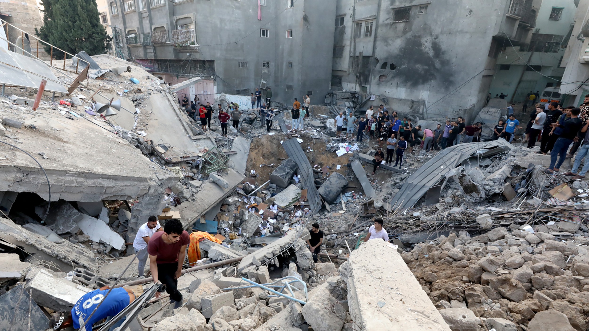 Palestinians search the destroyed annex of the Greek Orthodox Saint Porphyrius Church, in Gaza City on 20 October (AFP)