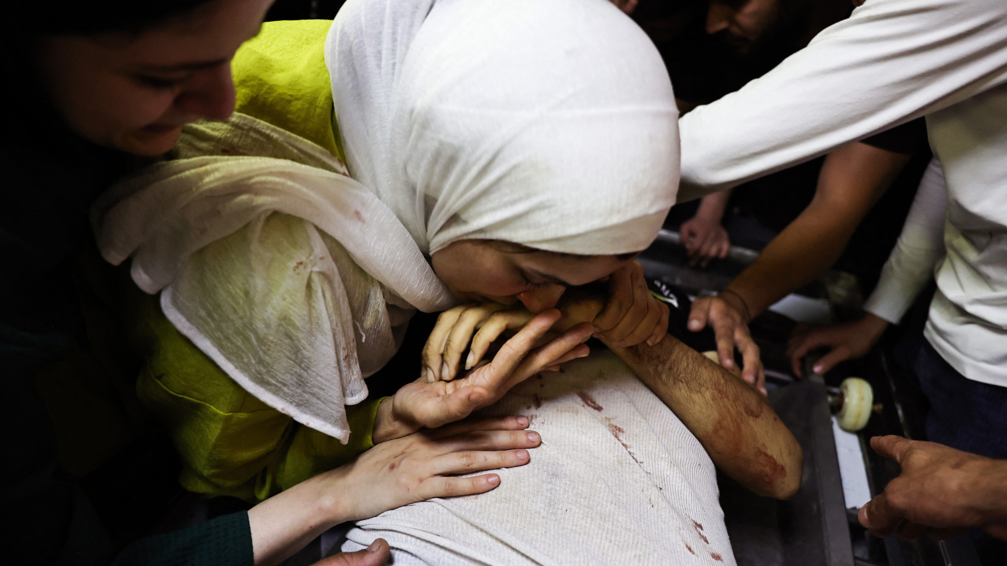 The sister of Mutaz Khaled Sadiq Nabulsi, who was killed by Israeli forces in occupied West Bank's Nablus, says her final farewells on 3 June 2024 (AFP/Zain Jaafar)