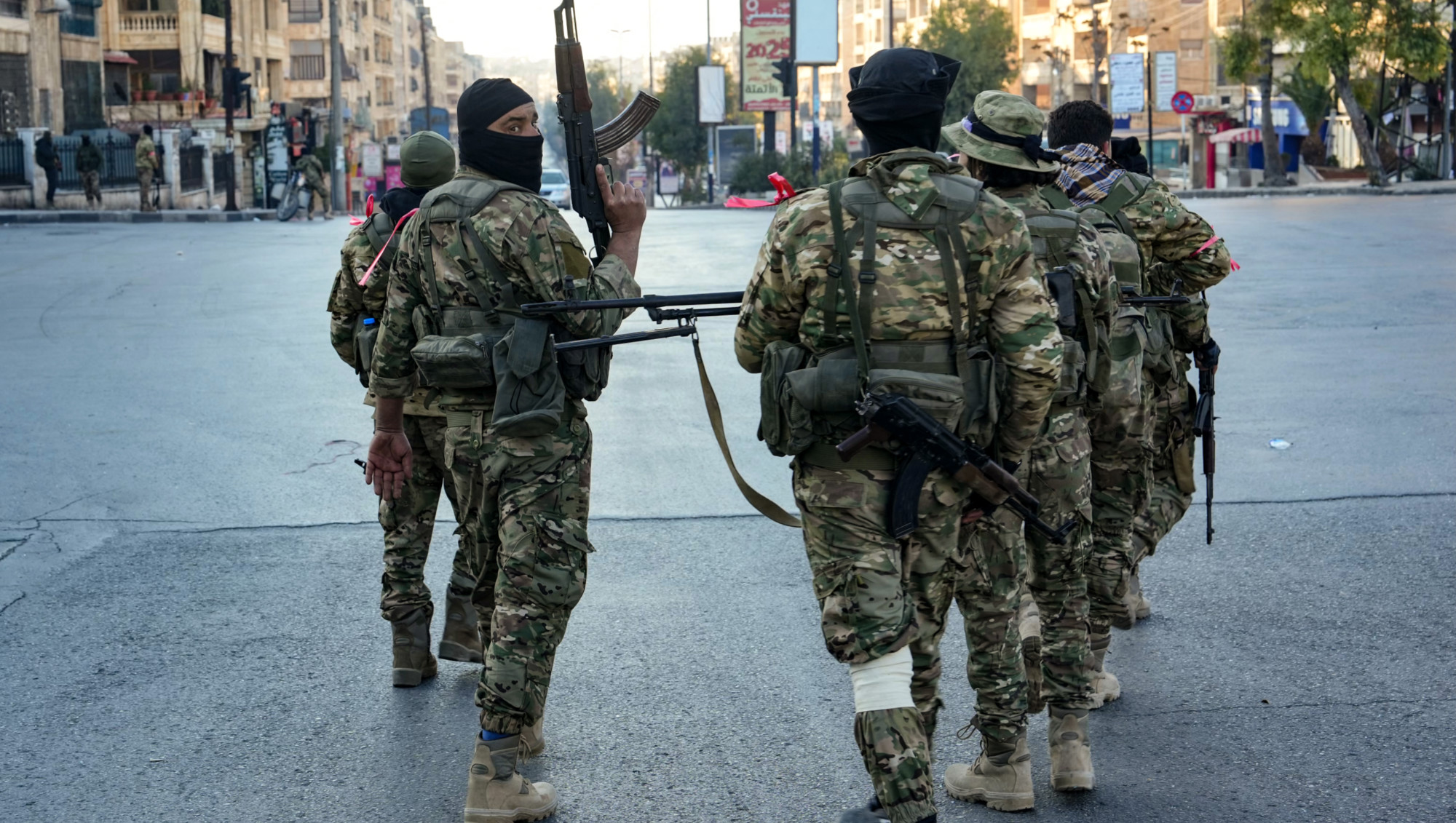 Anti-government fighters patrol in central Aleppo on 30 November 2024 (AFP/Muhammad Haj Kadour)