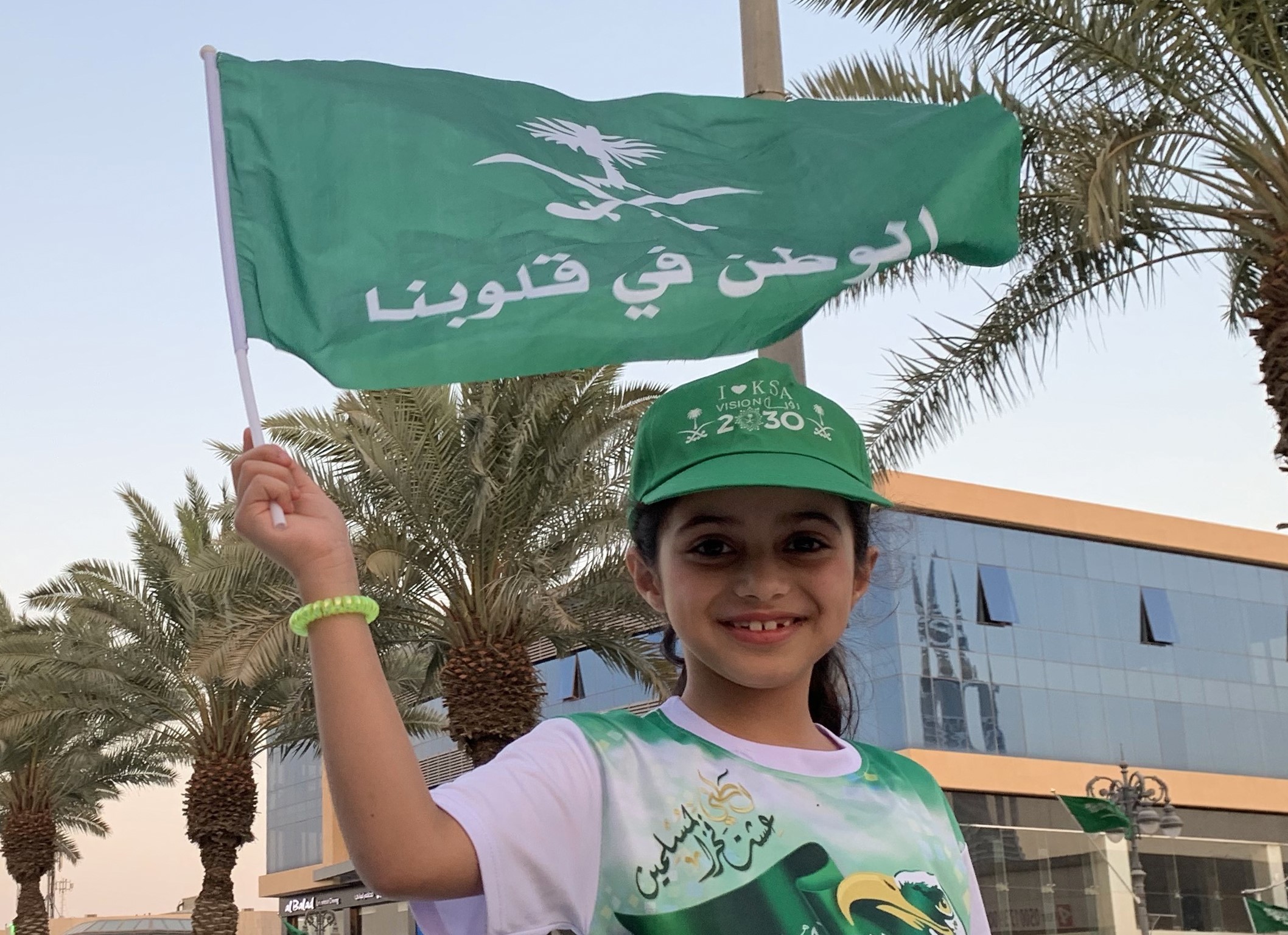 A girl waves a flag during celebrations in Riyadh marking Saudi Arabi's National Day on 23 September (AFP)