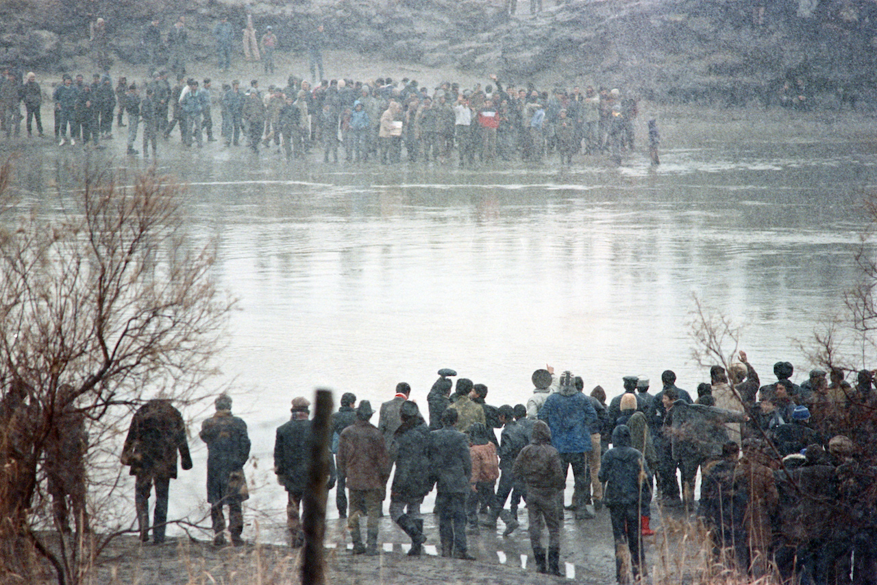 Azeri Nationalists of the Nakhchivan Autonomous Republic wave to Iranina Azeris gathered across the border of Aras River, on January 8, 1990, West Azerbaijan Province (AFP)