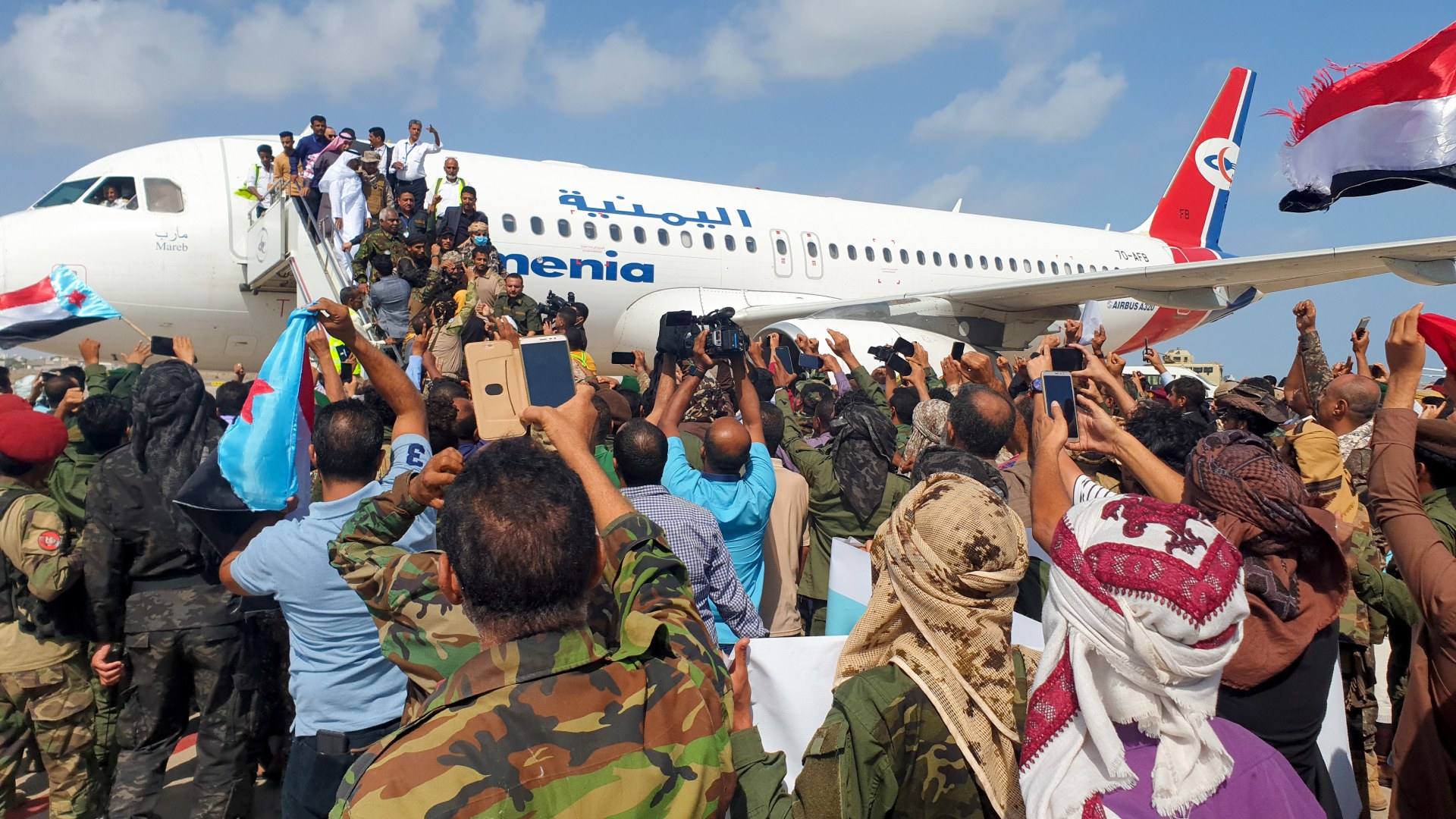 Yemenis welcome members of the new unity government at the Aden Airport before the attack (AFP)