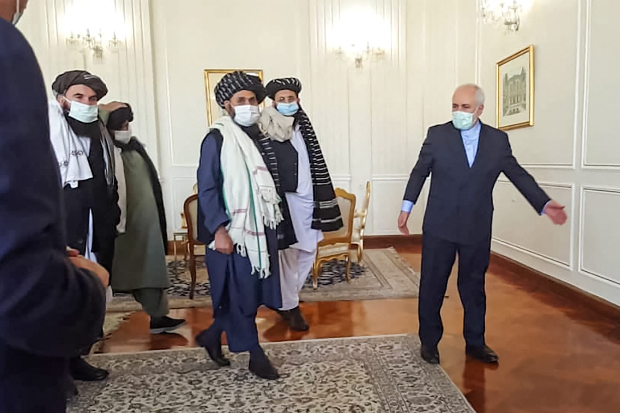 Iran's then-Foreign Minister Mohammad Javad Zarif meets with Taliban political chief Mullah Abdul Ghani Baradar in Tehran, 31 January (AFP)
