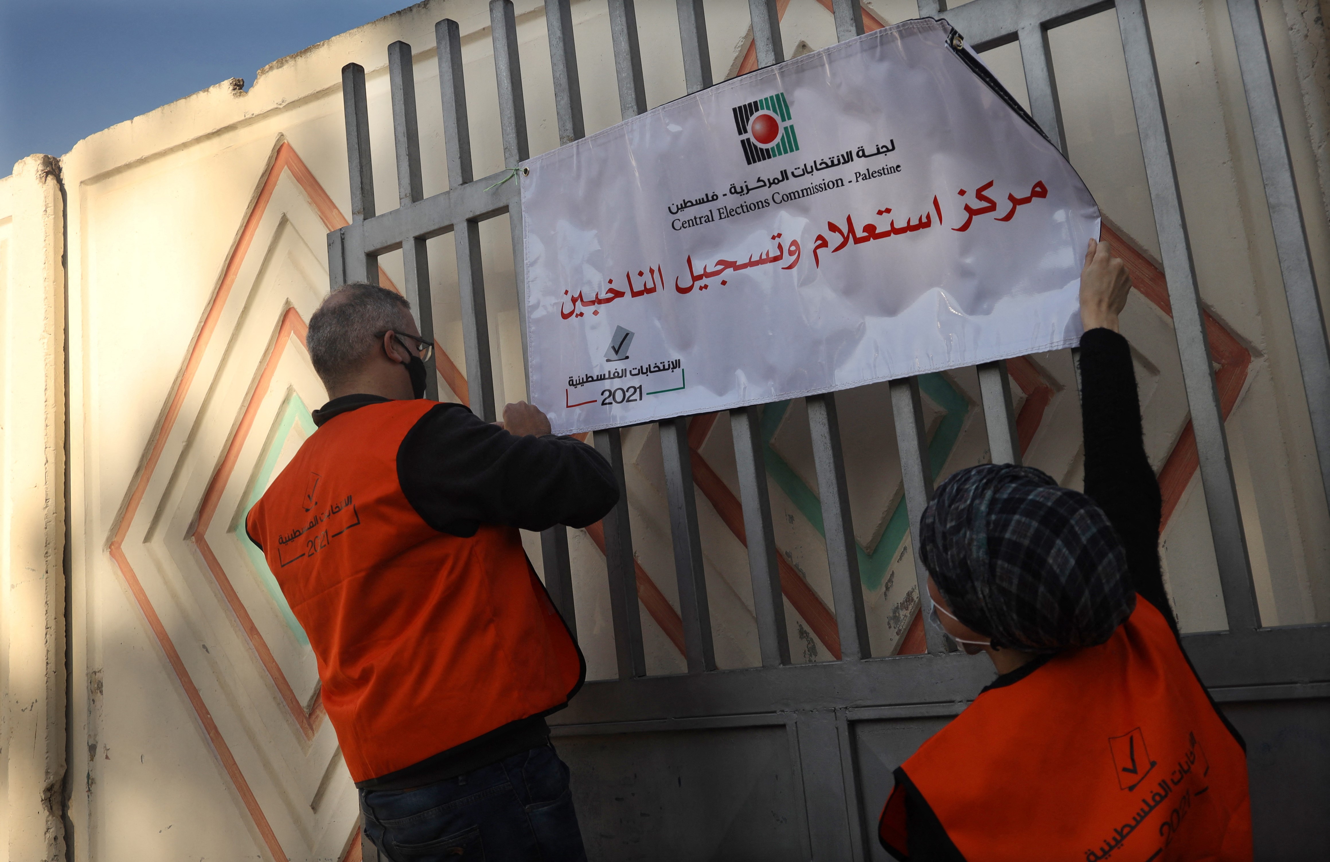 Palestinian members of Central Elections Commission open the first Voter Information and Registration Centre in Gaza City on February 10, 2021