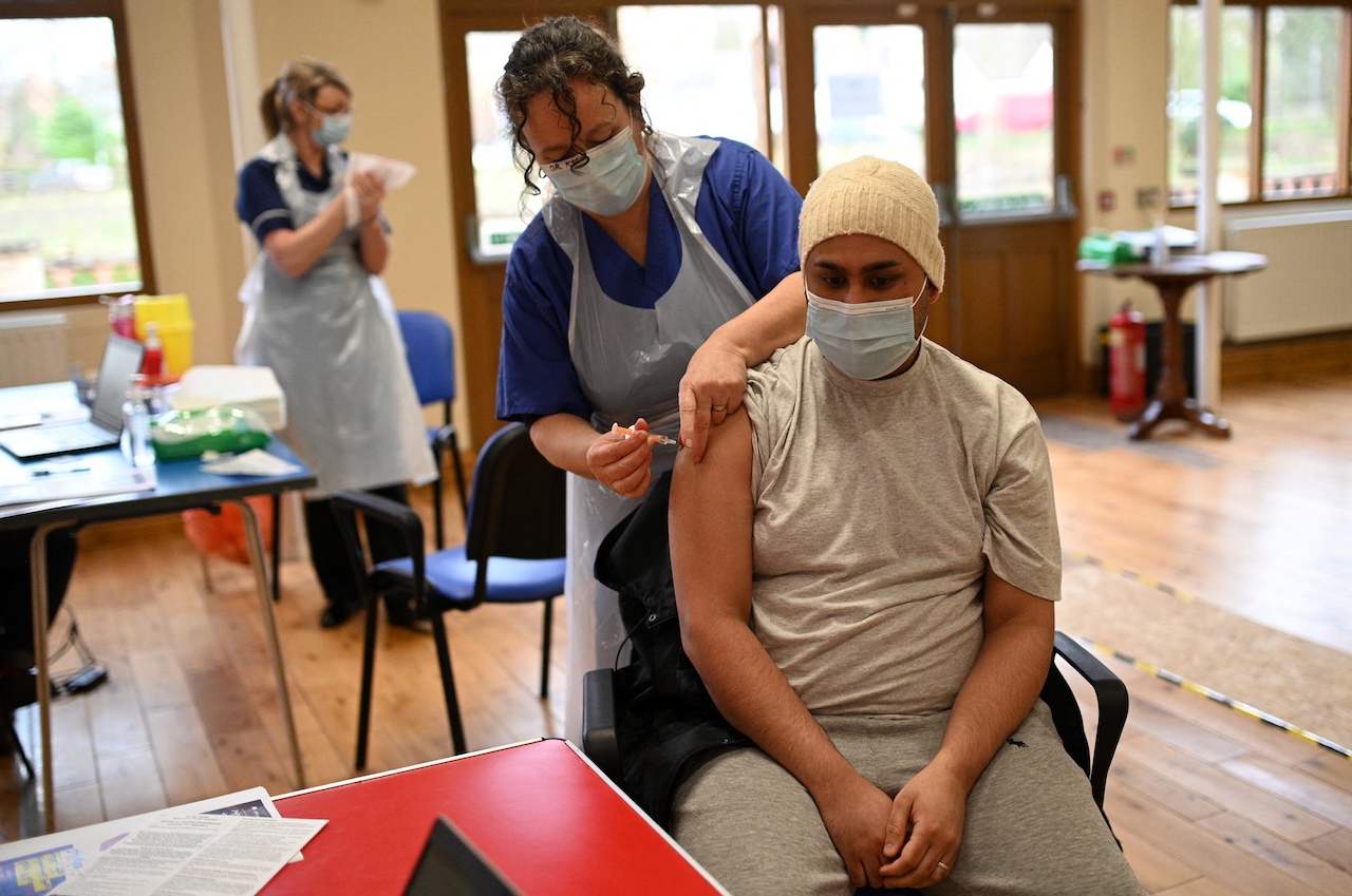 Dr Karen Worth administers a dose of the AstraZeneca/Oxford Covid-19 vaccine to a patient at a vaccination centre set up at the Fiveways Islamic Centre and Mosque in Nottingham, central England (AFP)