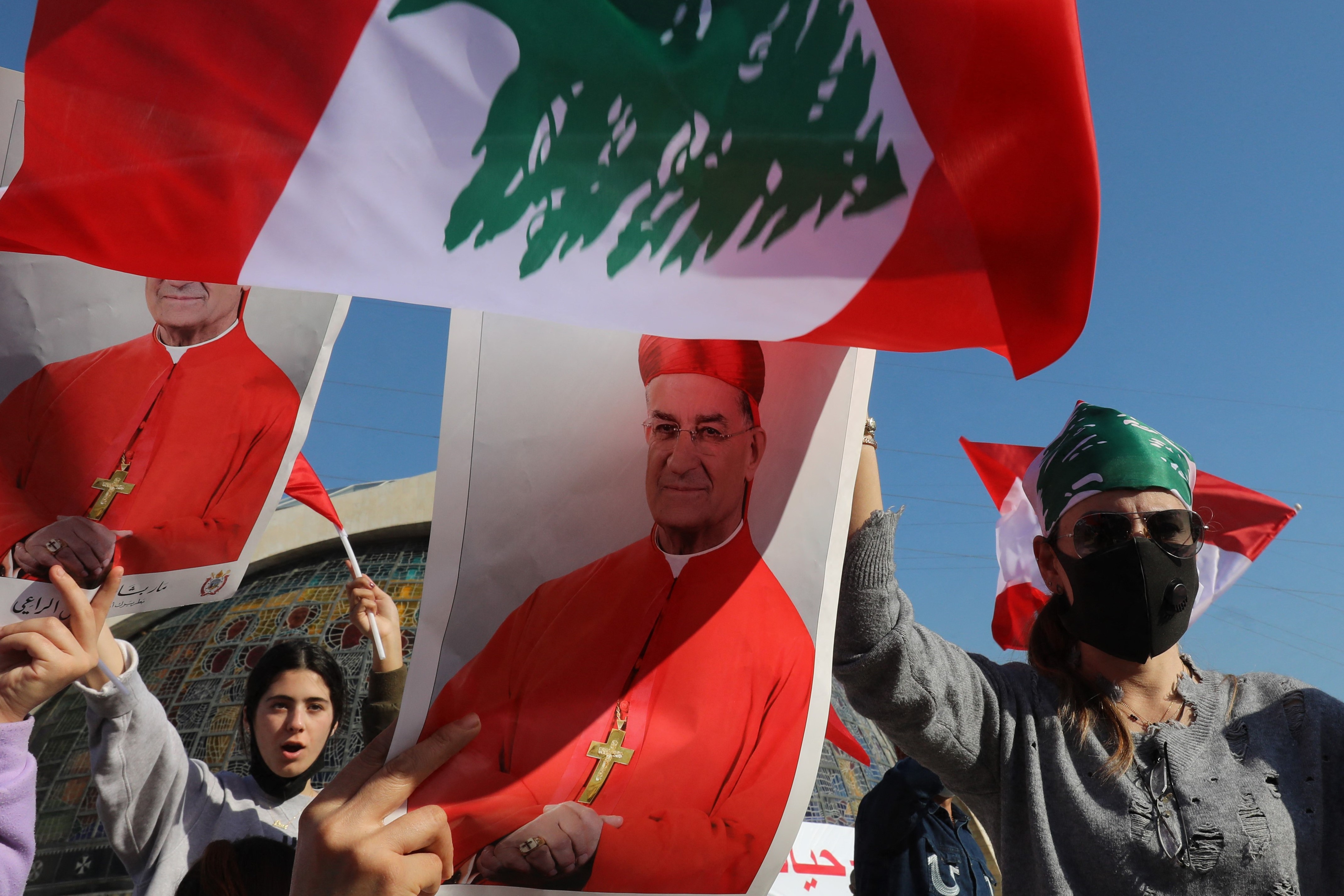 Lebanese protesters carry the portrait of Lebanon's Cardinal Mar Bechara Boutros al-Rahi (or Rai) ahead of his speech on February 27, 2021