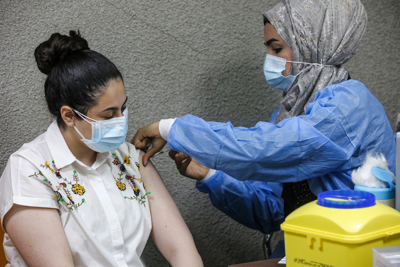 A nurse administers a dose of the Pfizer-BioNTech COVID-19 coronavirus vaccine at a vaccination centre in the Kindi Hospital in Iraq's capital Baghdad on 14 April 2021 (AFP) 
