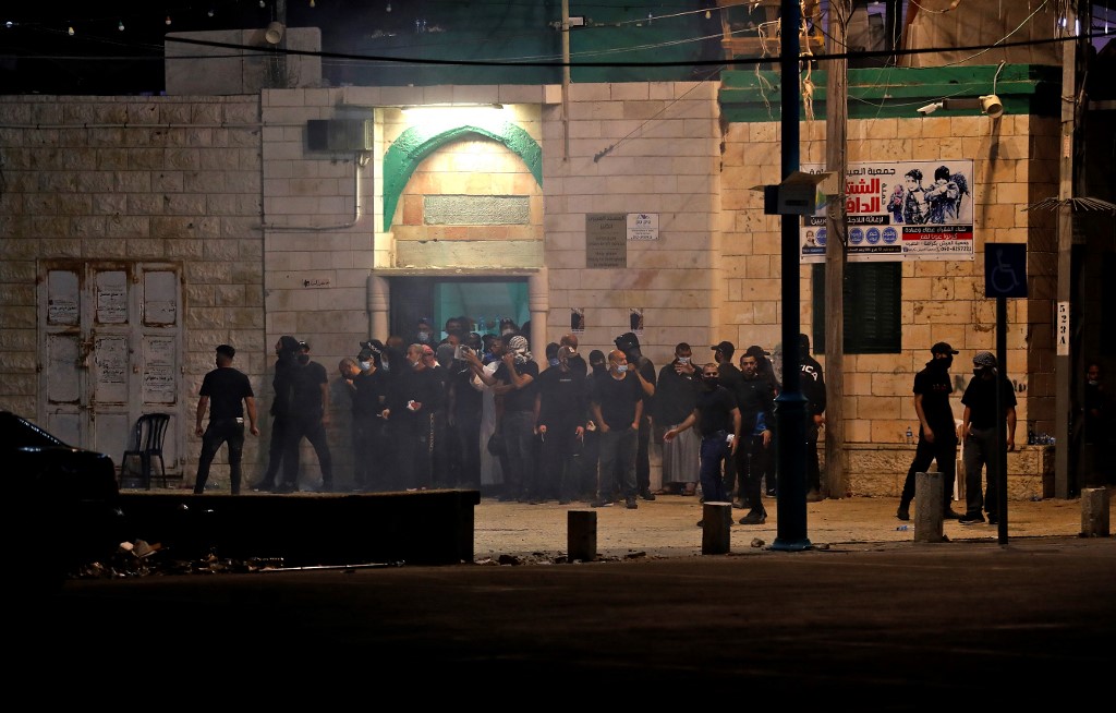 Arab-Israelis gather outside a mosque in the mixed Jewish-Arab city of Lod on May 13, 2021, to protect it from attacks by Israeli far-right extremist.