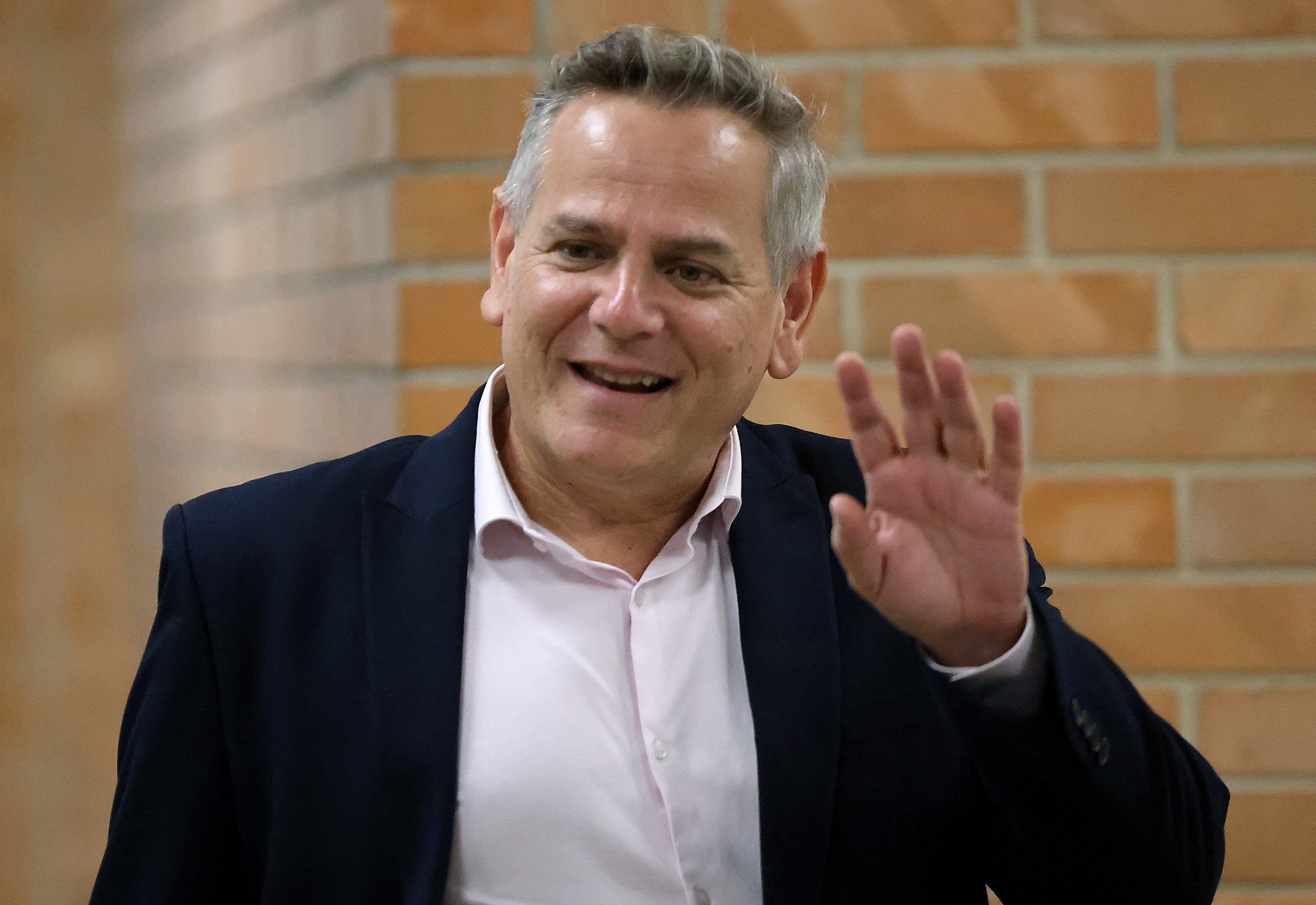 Israeli politician Nitzan Horowitz of the Meretz party waves as he arrives to attend a parliamentary meeting at the Knesset in Jerusalem, ahead of a vote on a new government, on 13 June, 2021. (AFP)