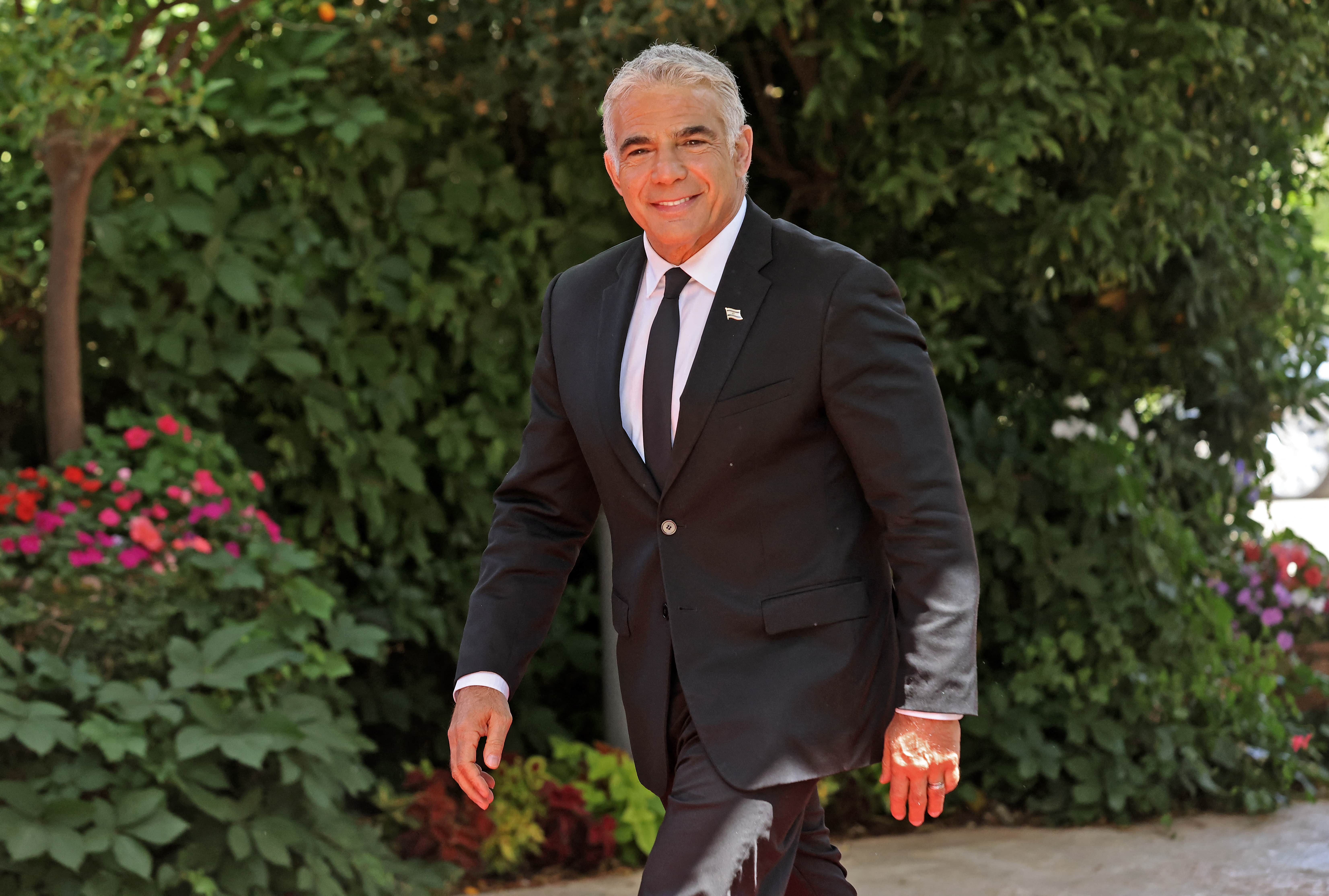 Leader of Israel's Yesh Atid party Yair Lapid arrives to the President's residence in Jerusalem for a picture, on June 14, 2021, a day after a new coalition government was voted in. (AFP)