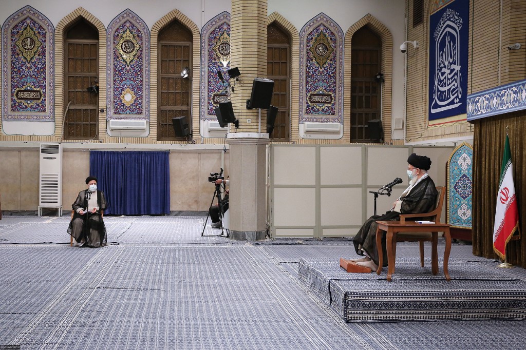 This handout picture provided by the office of Iran's Supreme Leader Ayatollah Ali Khamenei on June 28, 2021 shows him meeting with President Ebrahim Raisi (L) and officials in Tehran.