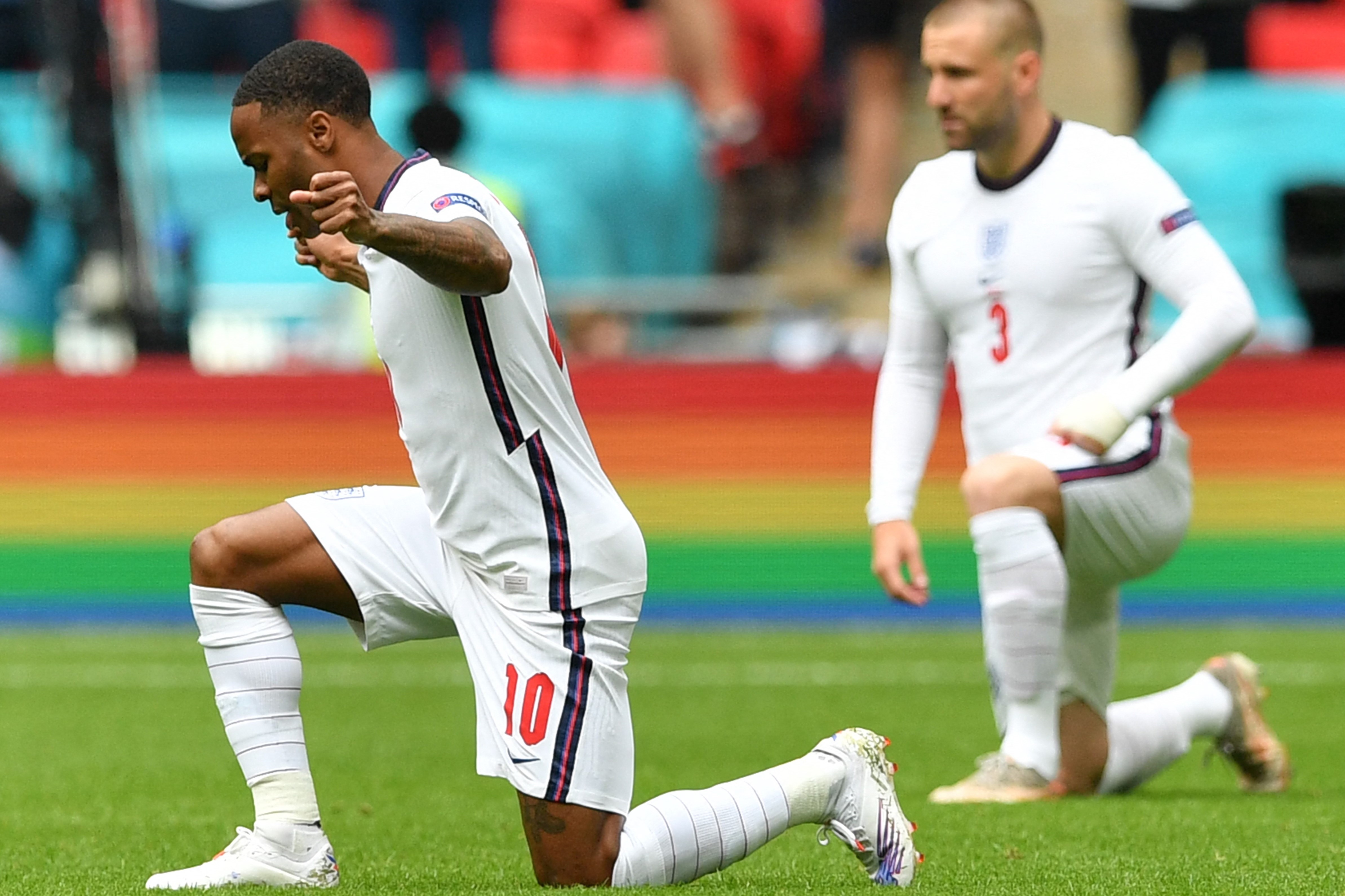 England's forward Raheem Sterling (L) takes a knee ahead of the UEFA EURO 2020 round of 16 football match between England and Germany at Wembley Stadium in London on June 29, 2021.