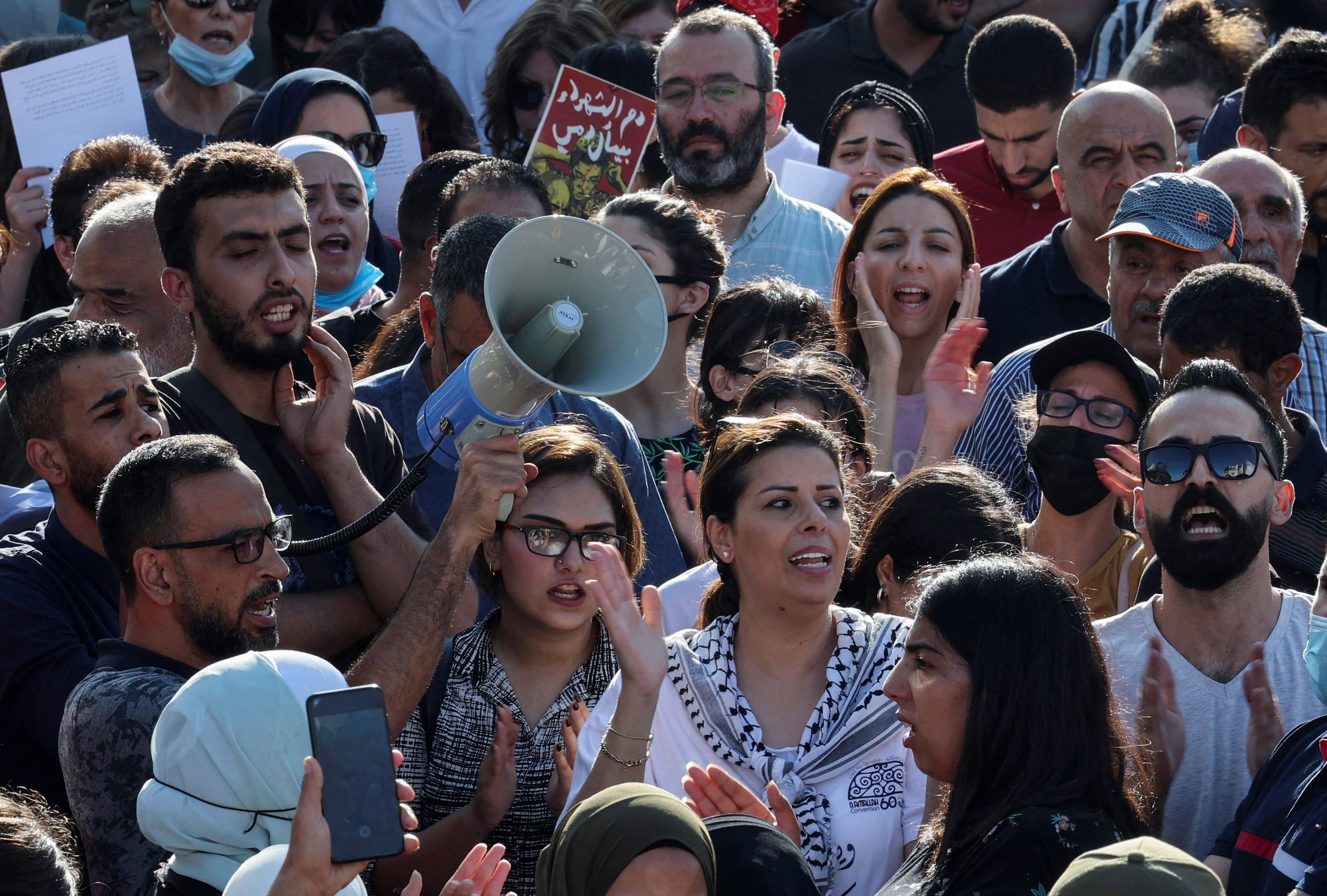 Palestinian demonstrators chant during a rally in Ramallah city in the occupied West Bank on July 11, 2021