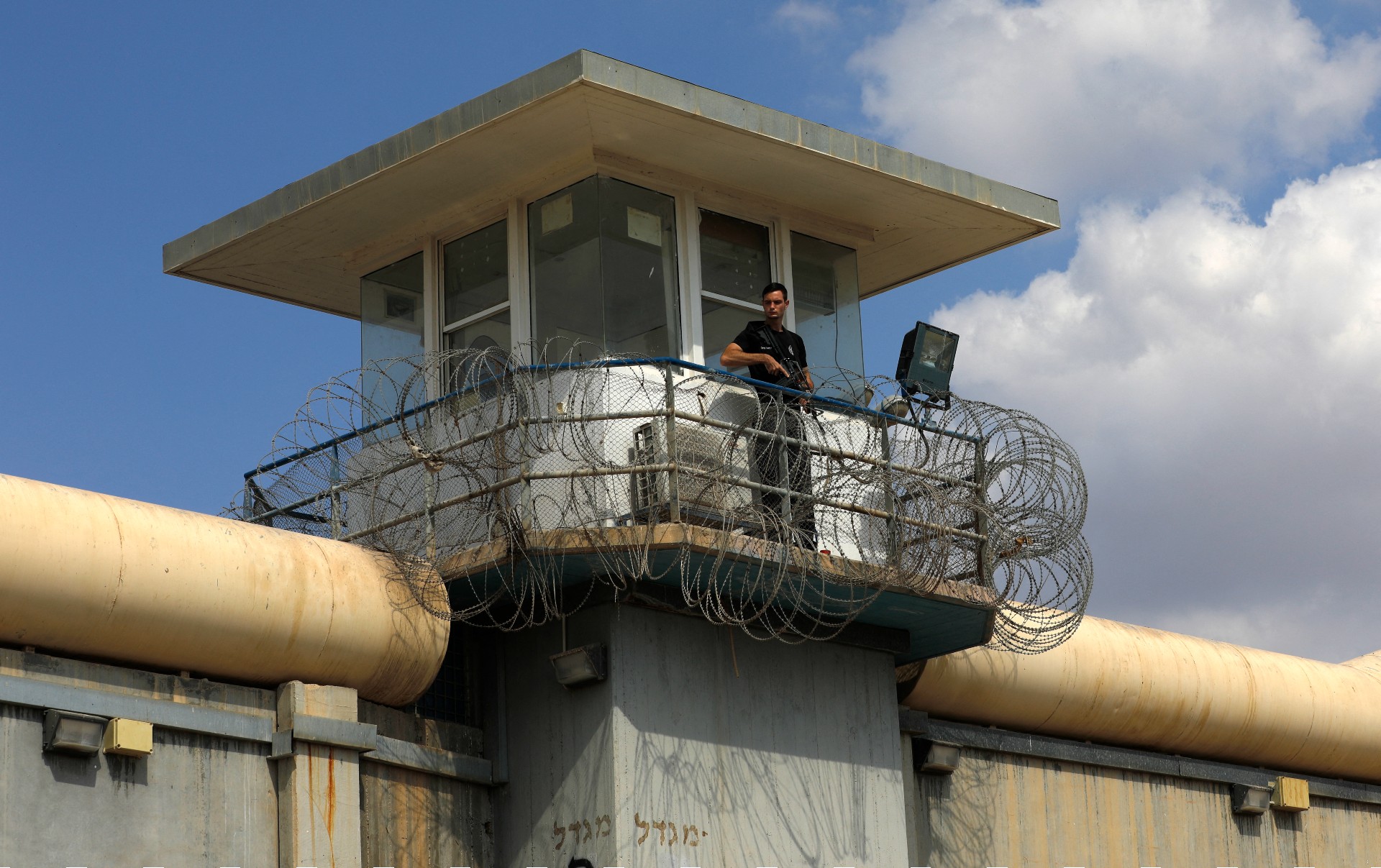 A police officer keeps watch from an observation tower at the Gilboa Prison in northern Israel (AFP)