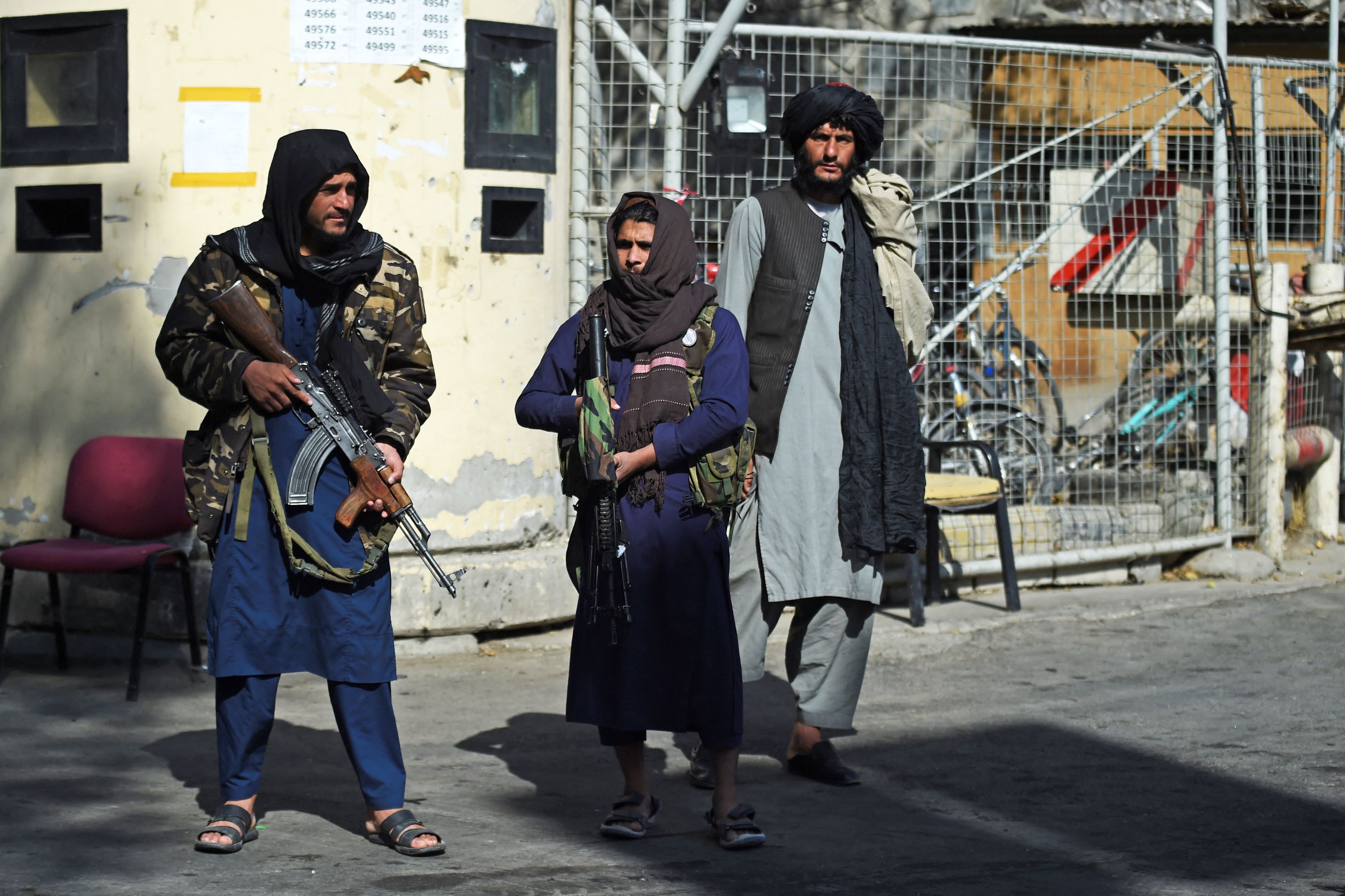 Taliban fighters stand guard at an entrance gate of the Sardar Mohammad Dawood Khan military hospital in Kabul on November 3, 2021, a day after an Islamic State attack (AFP)