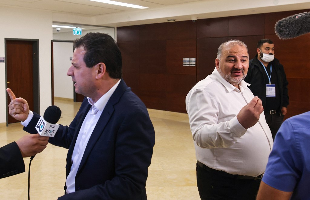 Ayman Odeh (L) and Mansour Abbas (R) talk to reporters following a session at the Knesset in Jerusalem on 4 November 2021 (AFP)