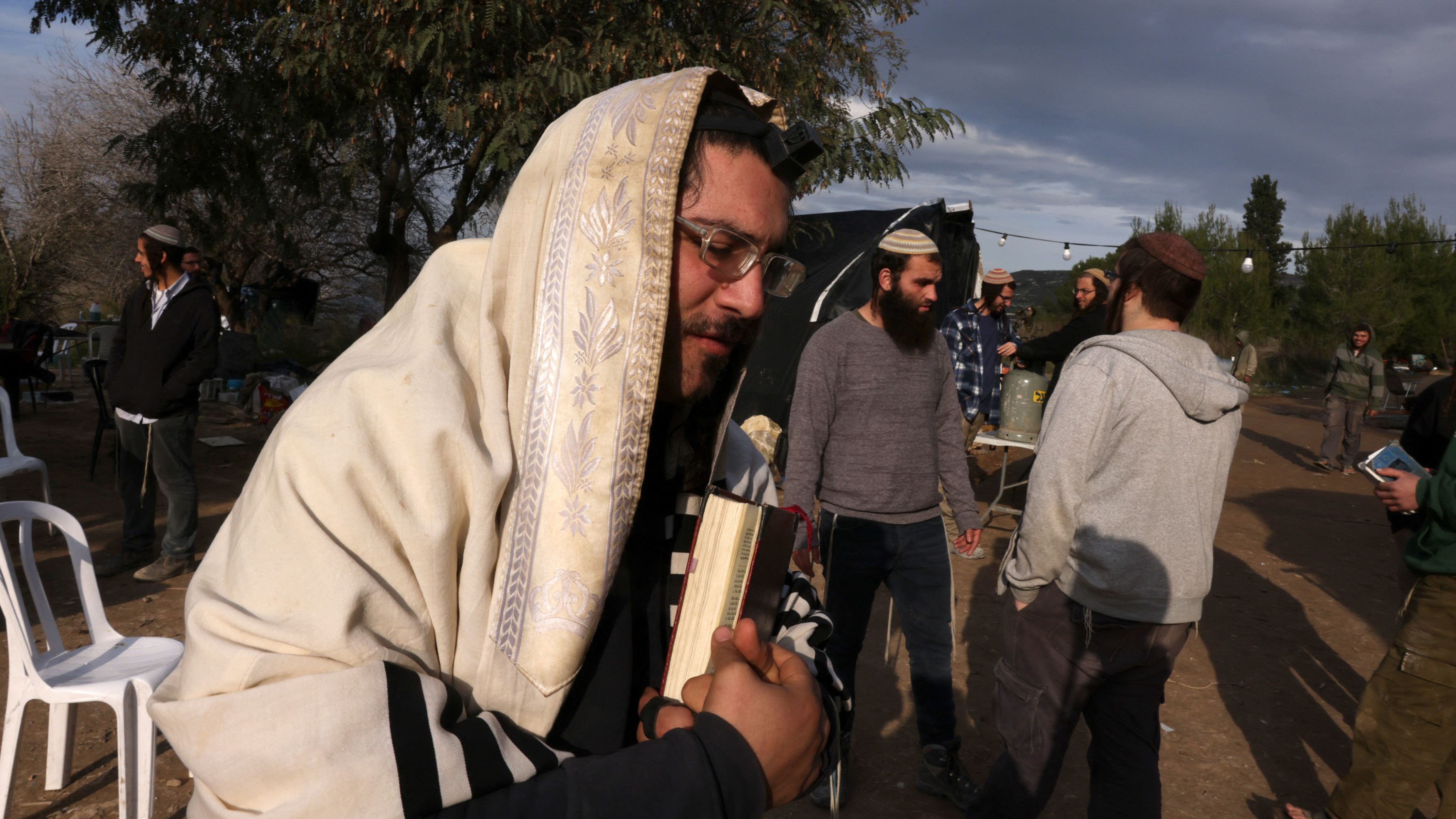 Des colons Israéliens et des étudiants de la yeshiva de Homesh se rassemblent dans une ancienne colonie près de Naplouse en Cisjordanie occupée, le 20 décembre 2021 (Reuters)